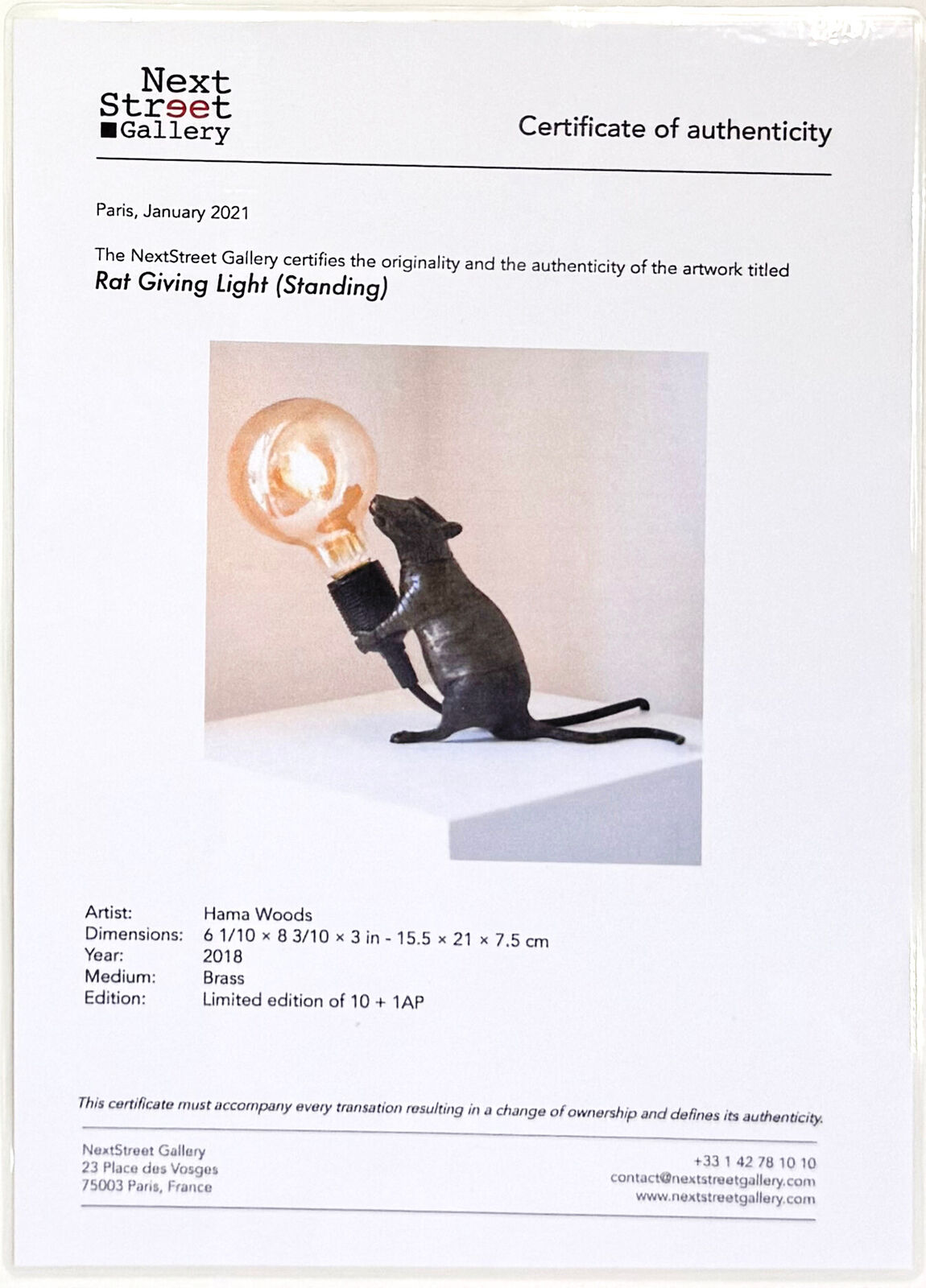 A rat lamp with a light bulb on top of it.