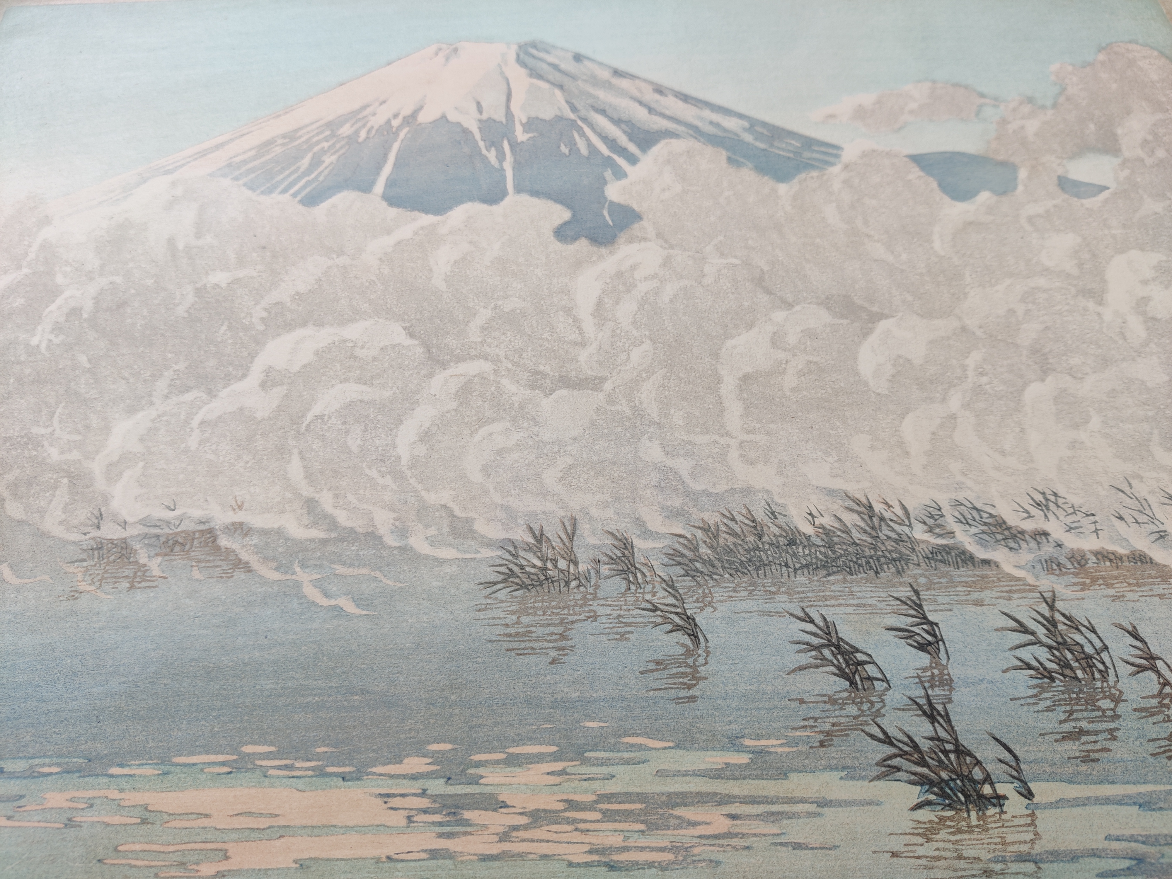 A painting of a mountain with clouds in the sky.
