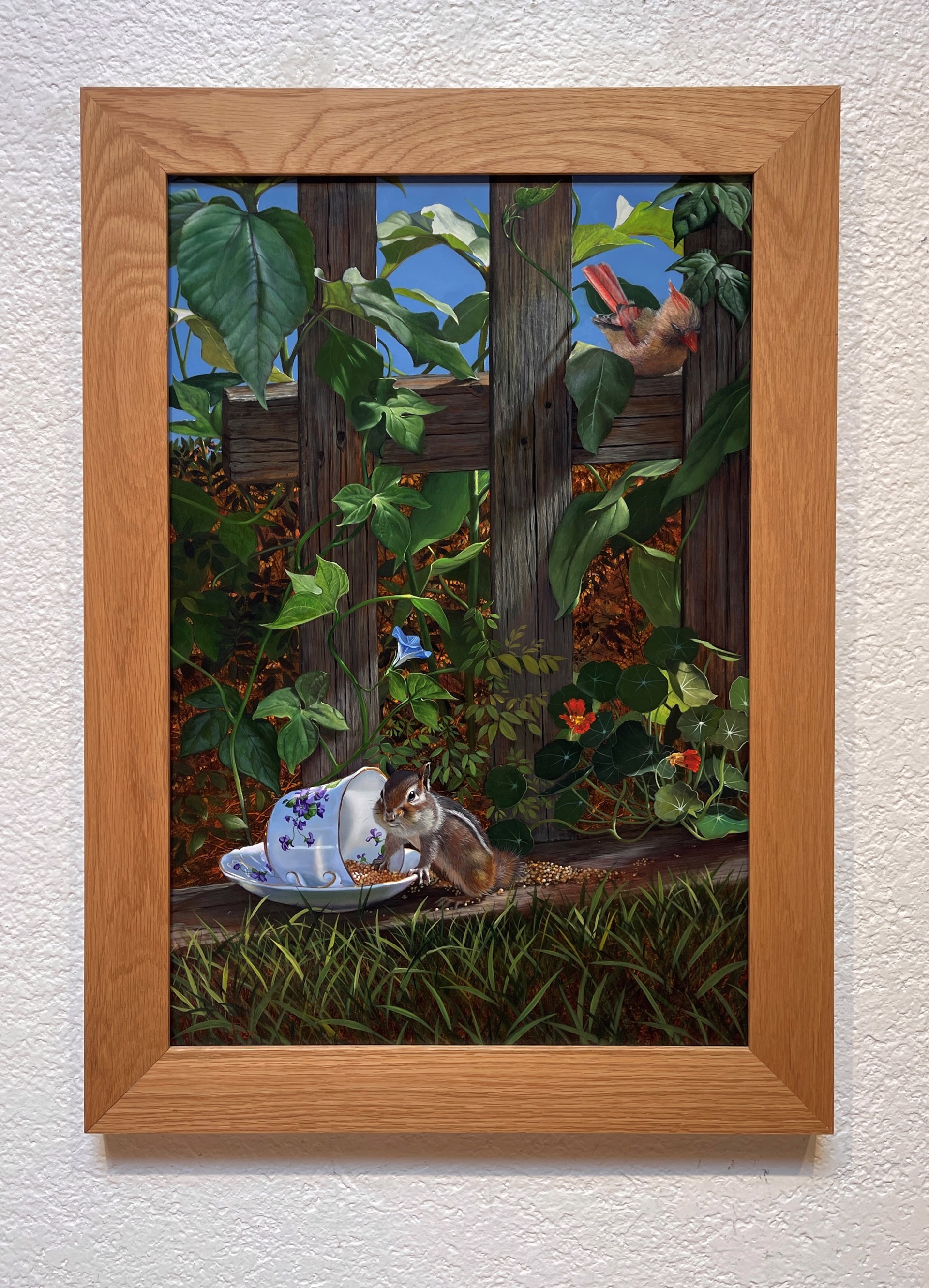 A painting of a chipmunk eating from a teacup in a garden.
