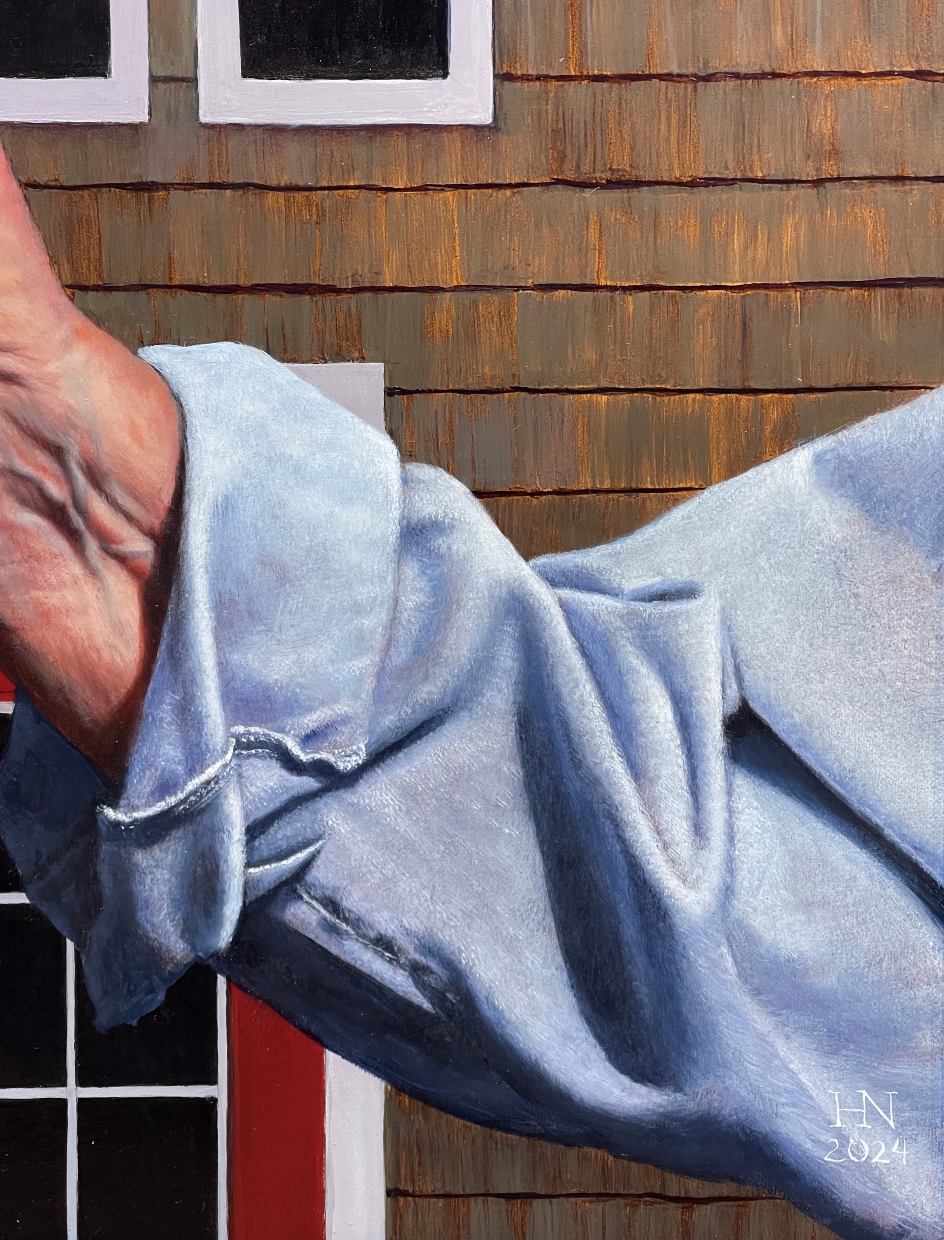 A painting of two hands holding a pitchfork in front of a house.