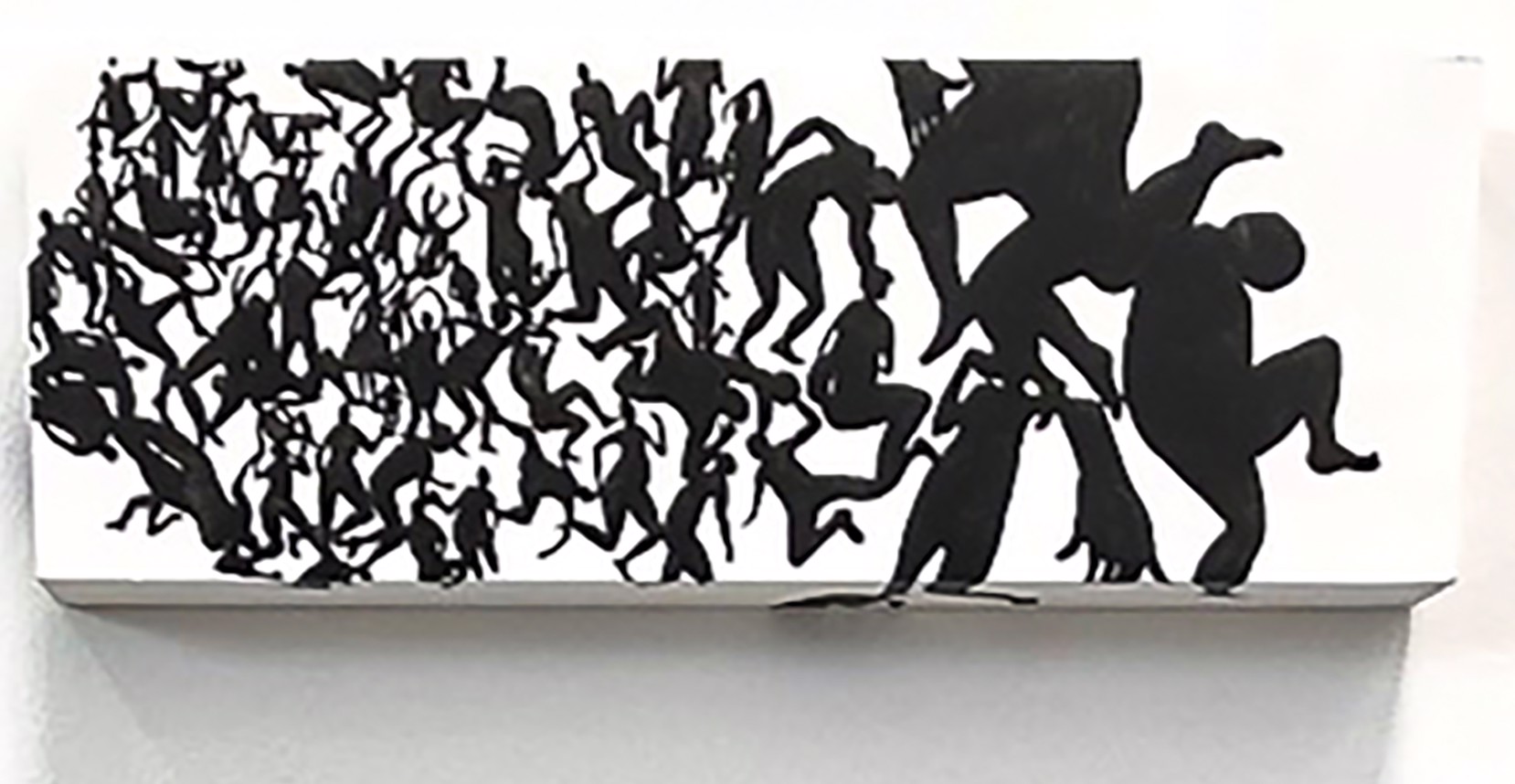 A metal sculpture of a group of people dancing on a wall.