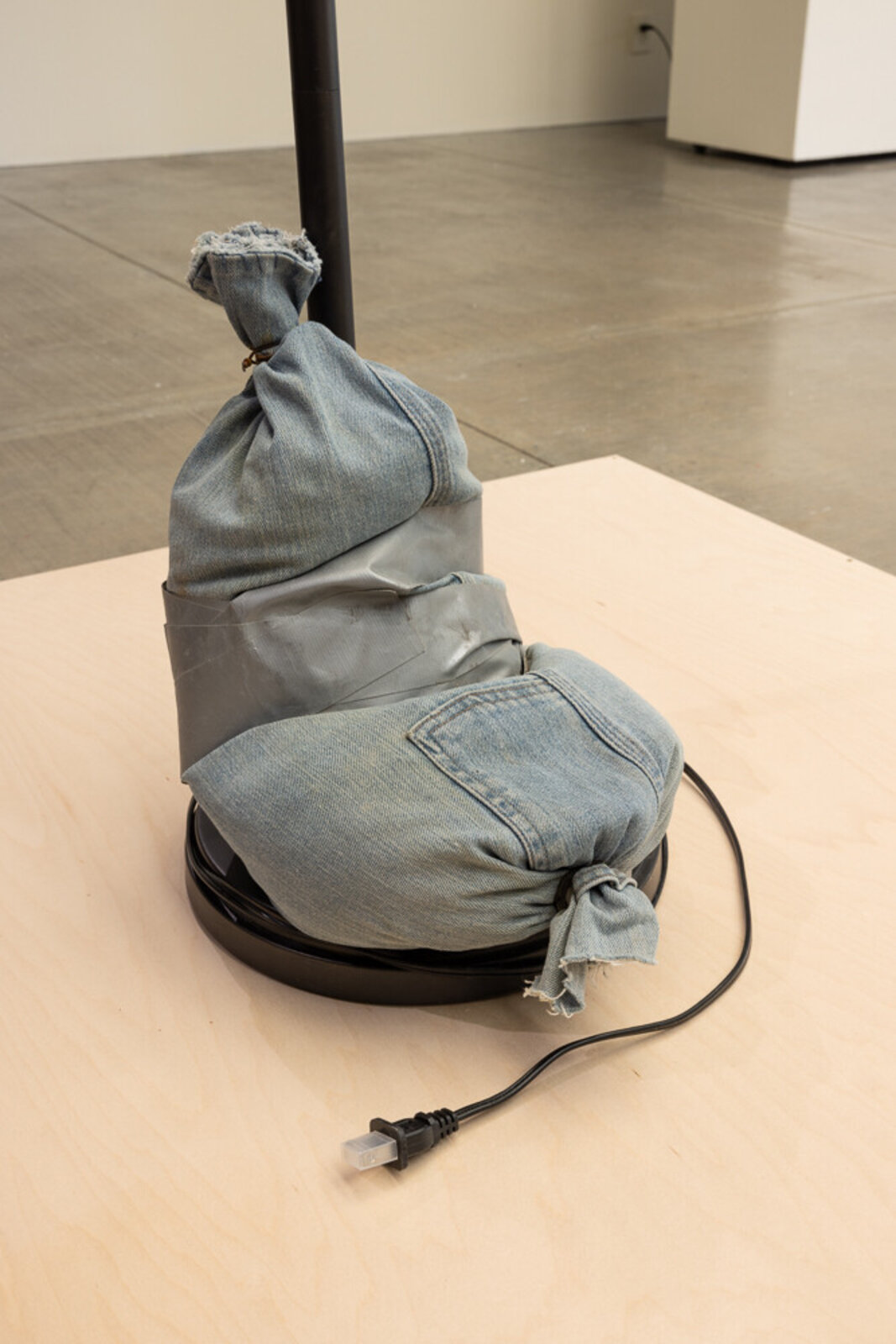 Artwork by Heidi Schwegler, Adult Situations, Made of Found object, wax, denim sandbag 