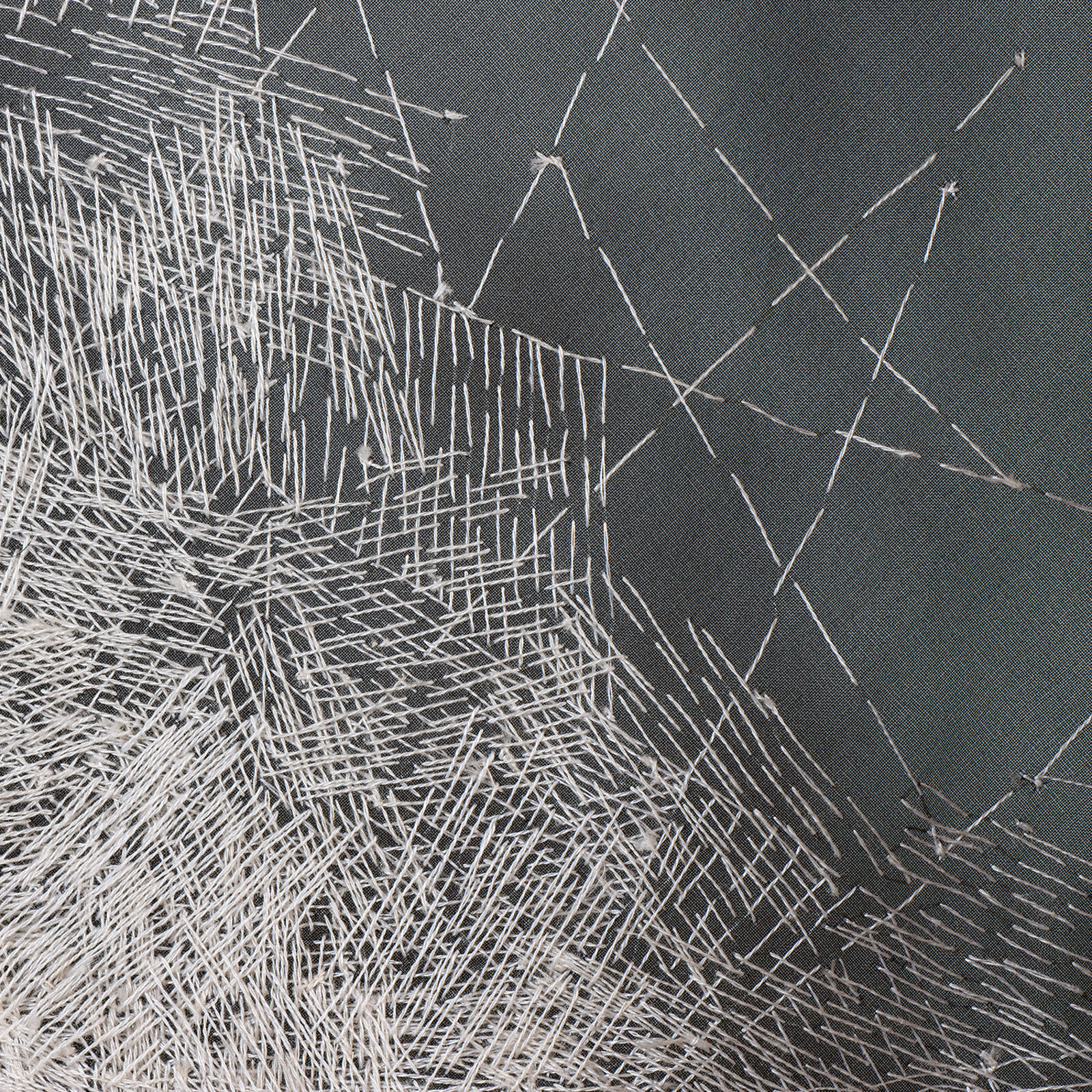 A minimalist textile sculpture featuring a folded triangular form with contrasting textures.