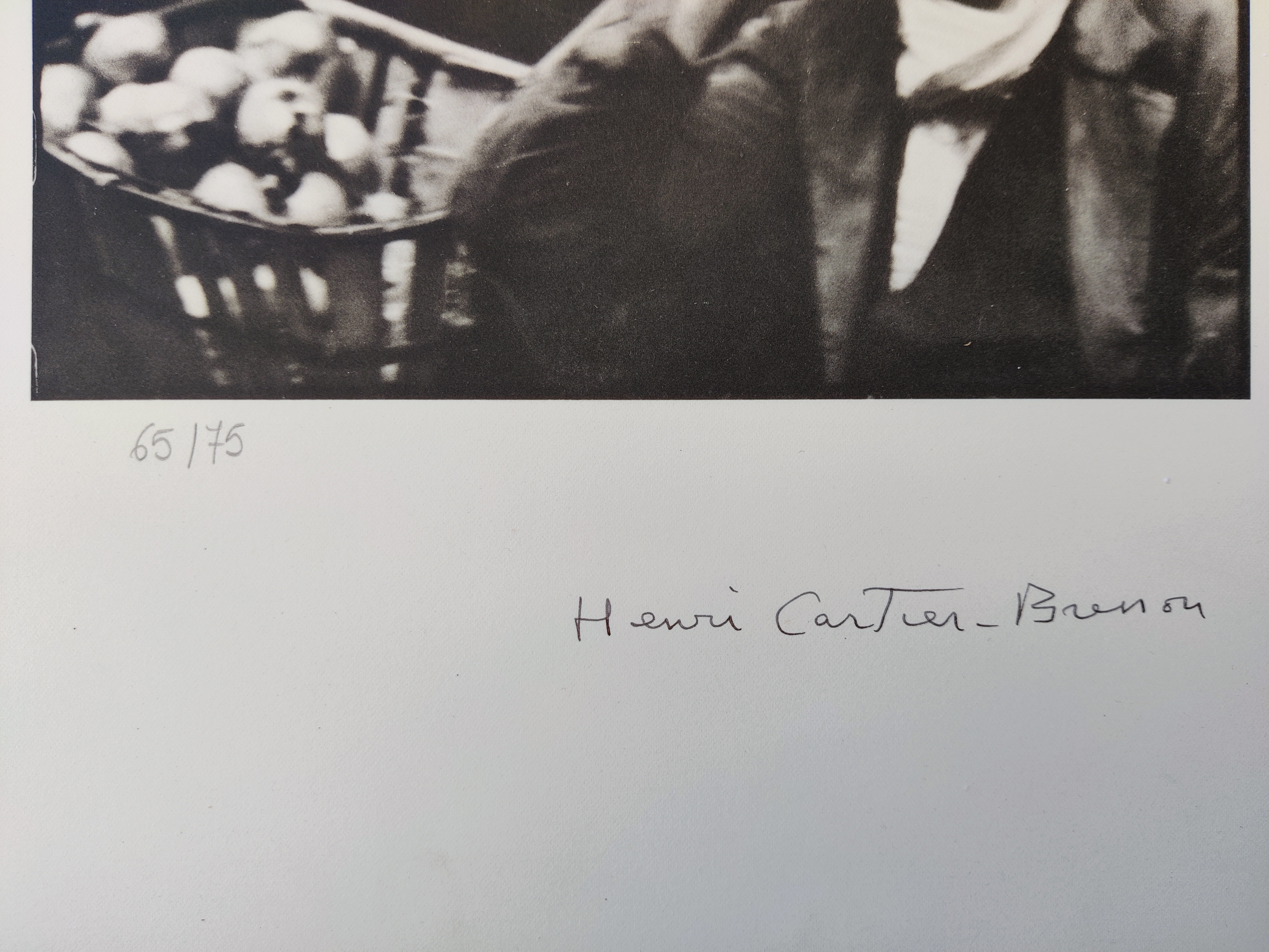 A black and white photo of a man talking on a cell phone.