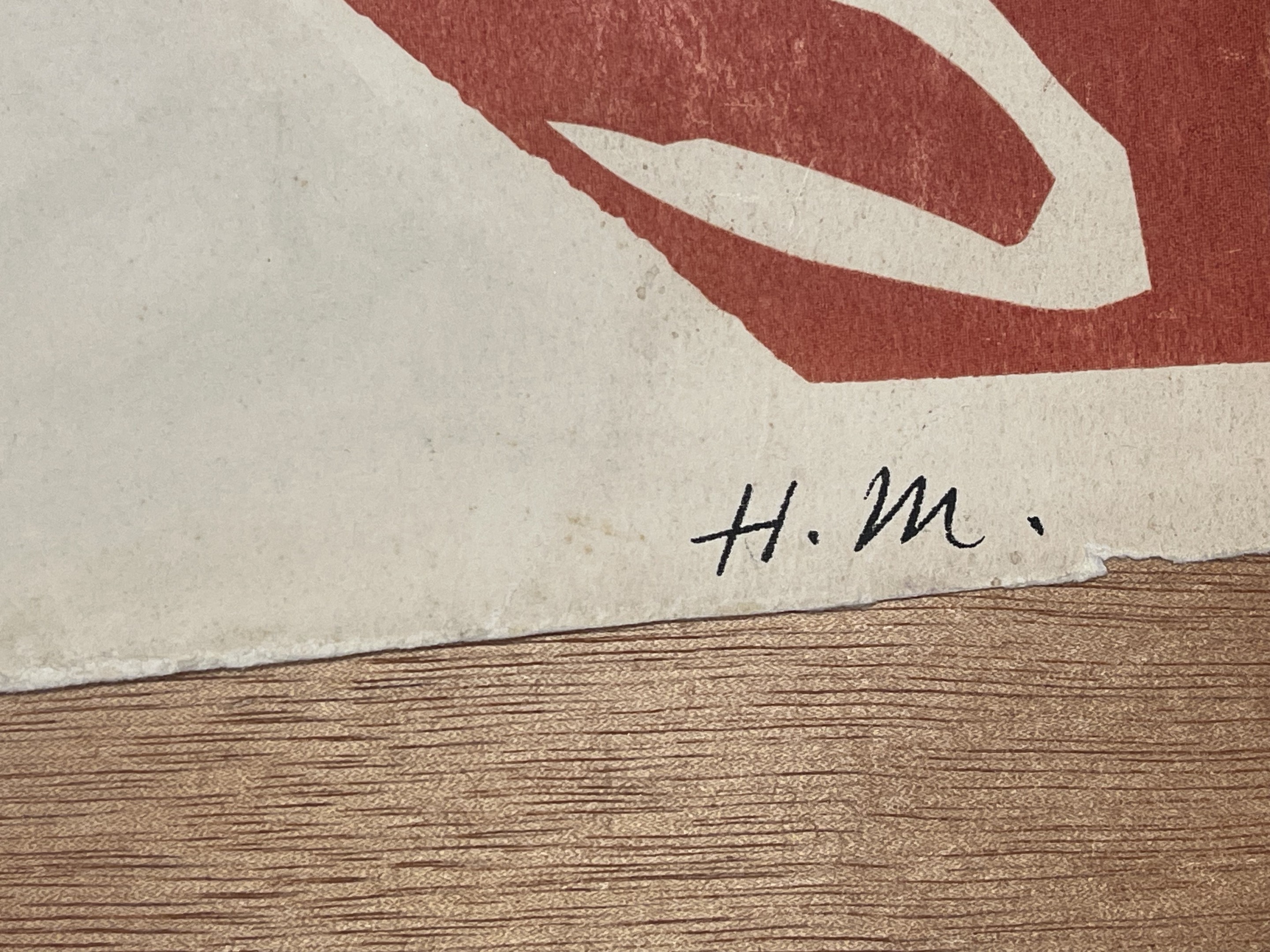 A person holding up a piece of paper with a painting on it.