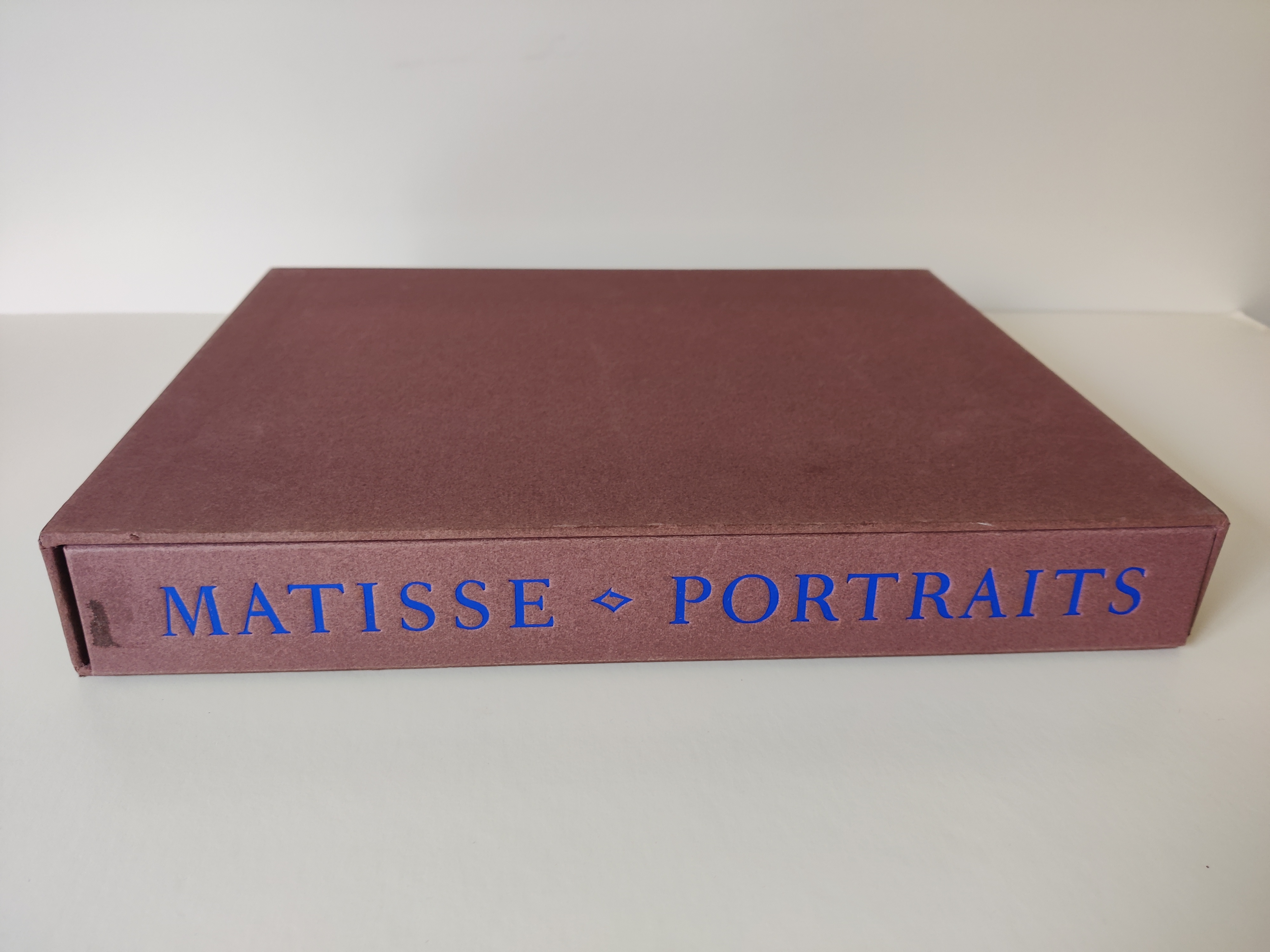 A graphic portrait book cover featuring a stylized face in bold colors.