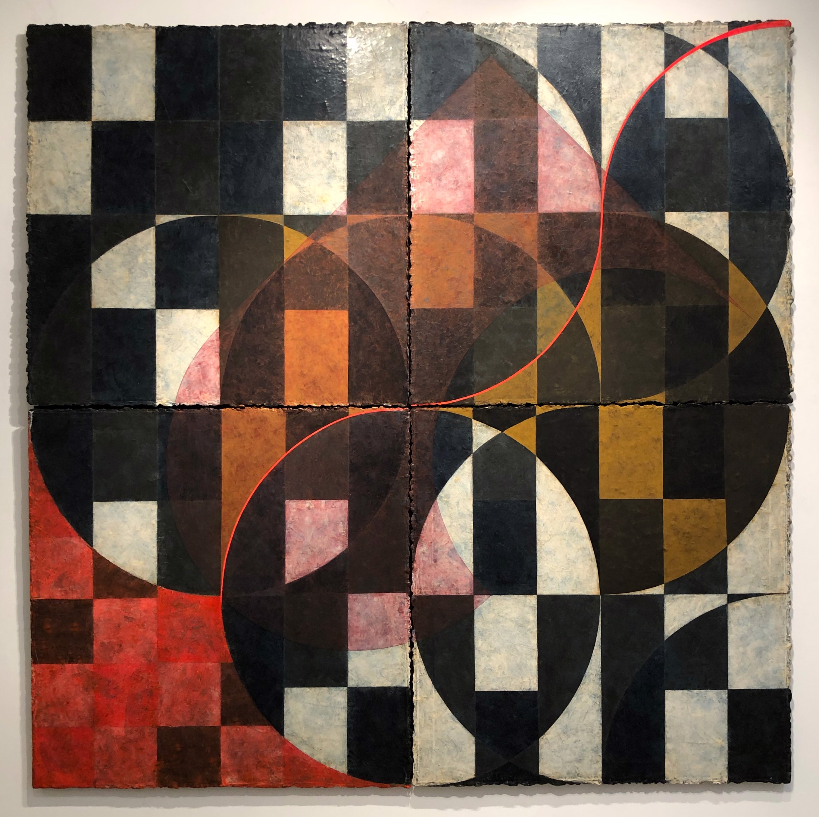 A painting on a wall with a geometric design on it.