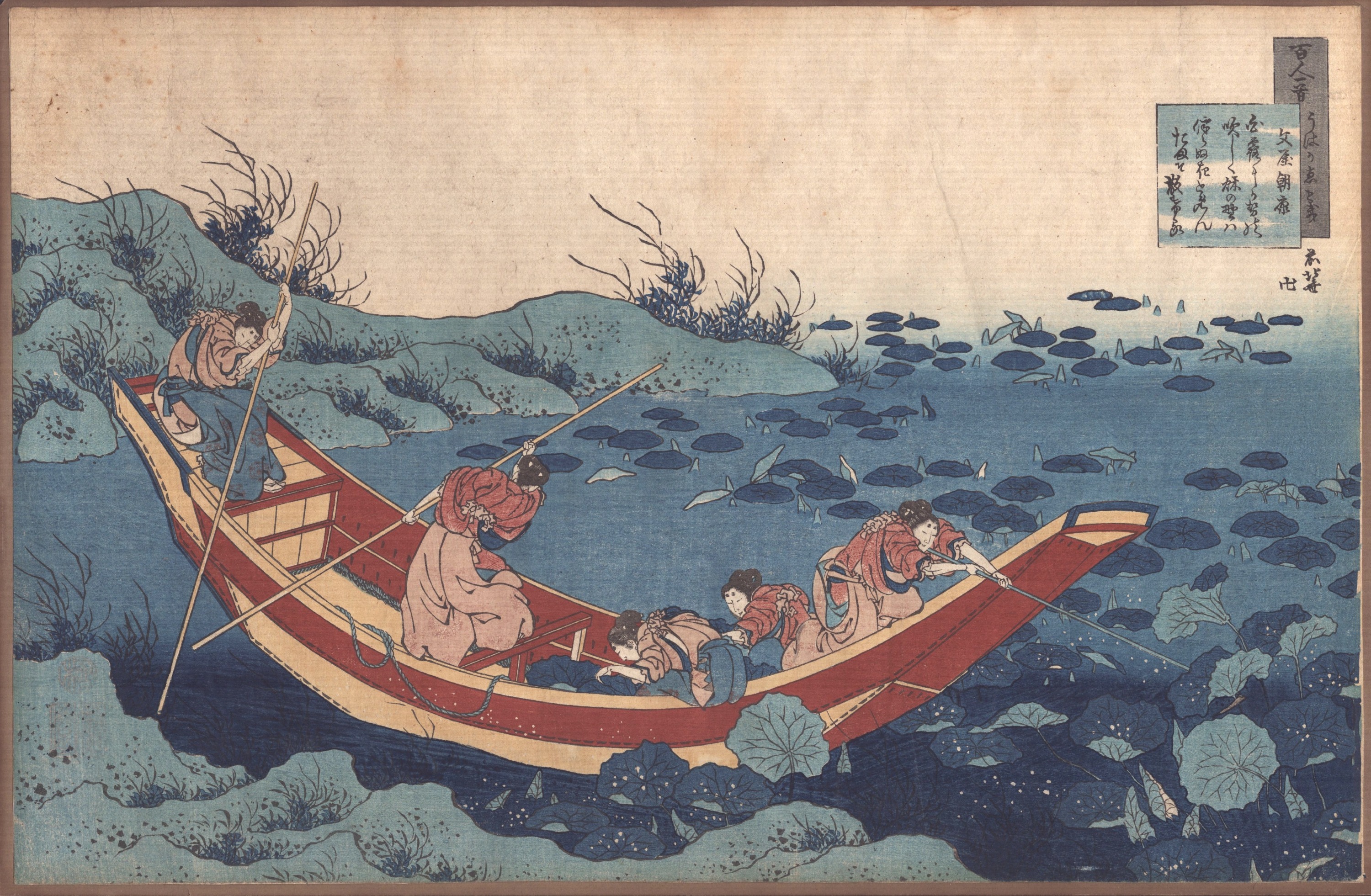 A group of people in a boat on a body of water.