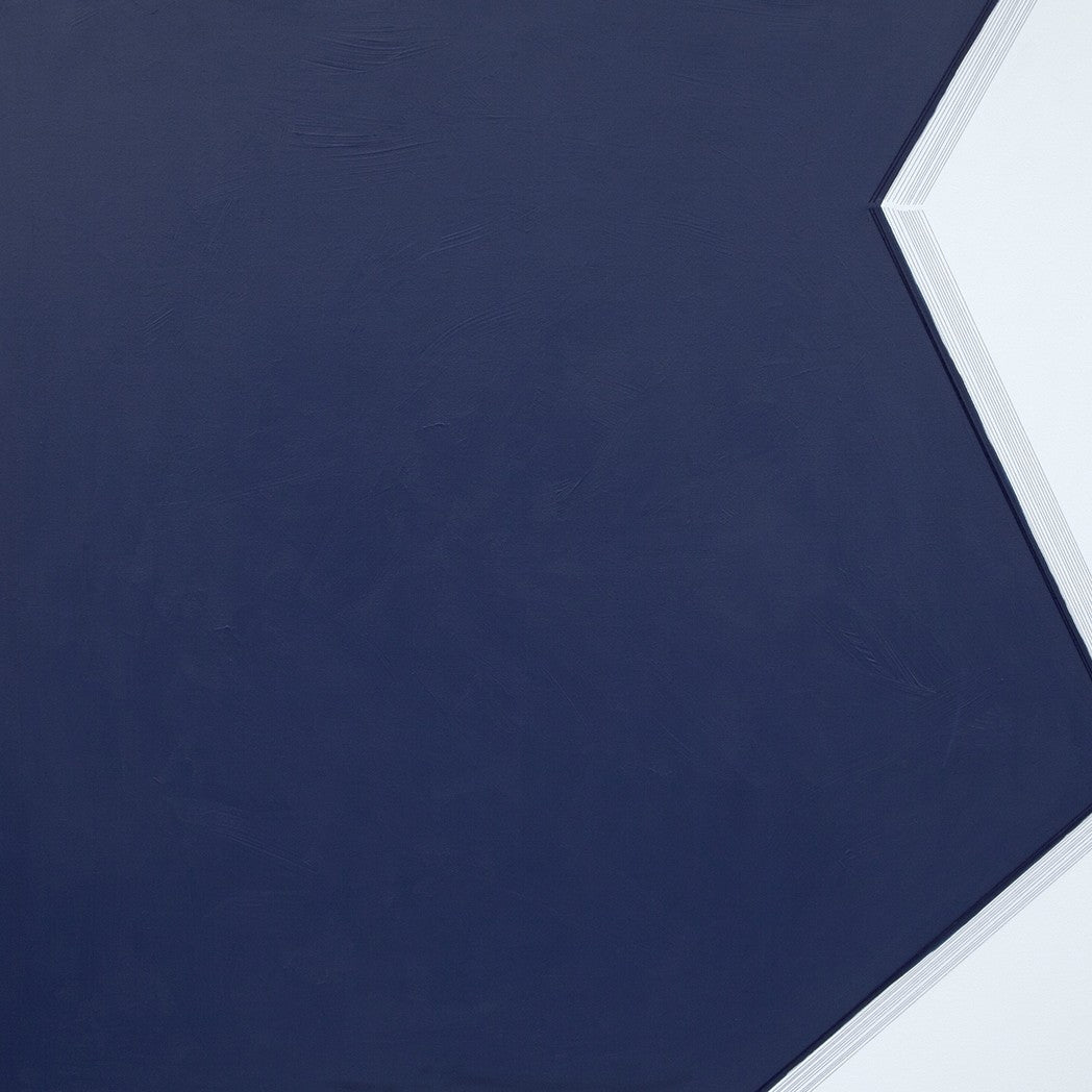 A blue and white painting on a white wall.