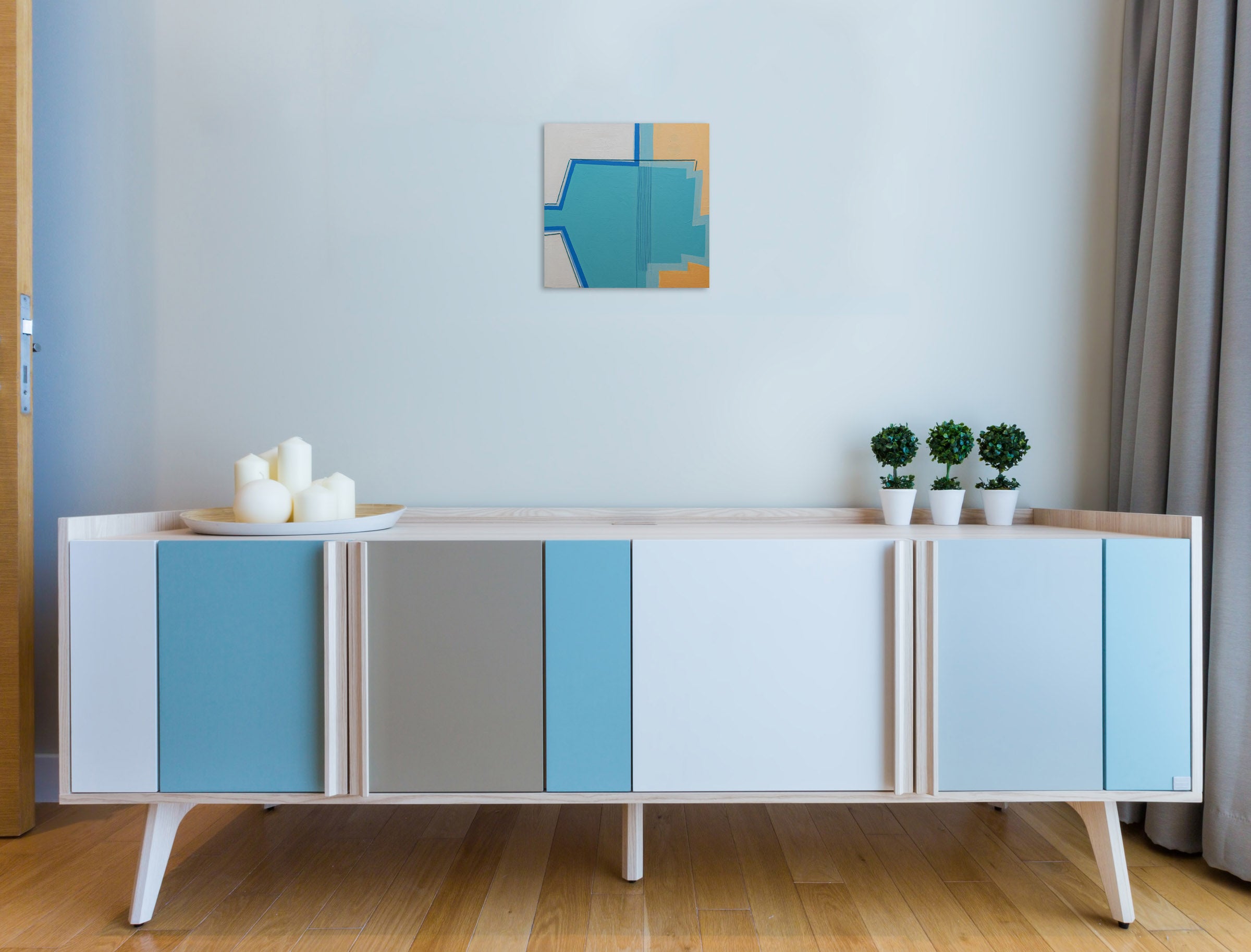 A painting of a blue and yellow abstract design.