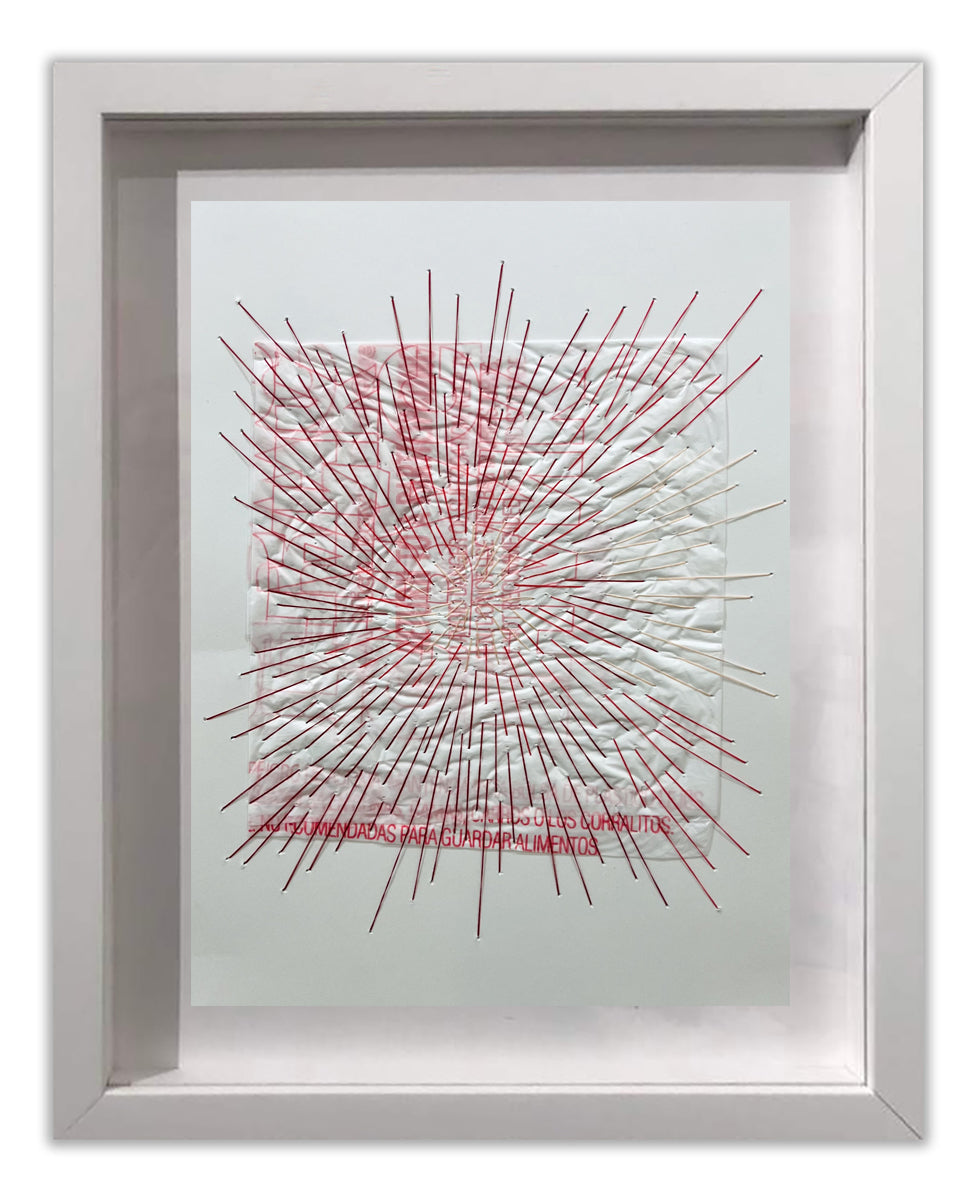 A picture of a white frame with a red and white drawing on it.
