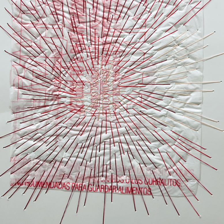 A picture of a white frame with a red and white drawing on it.