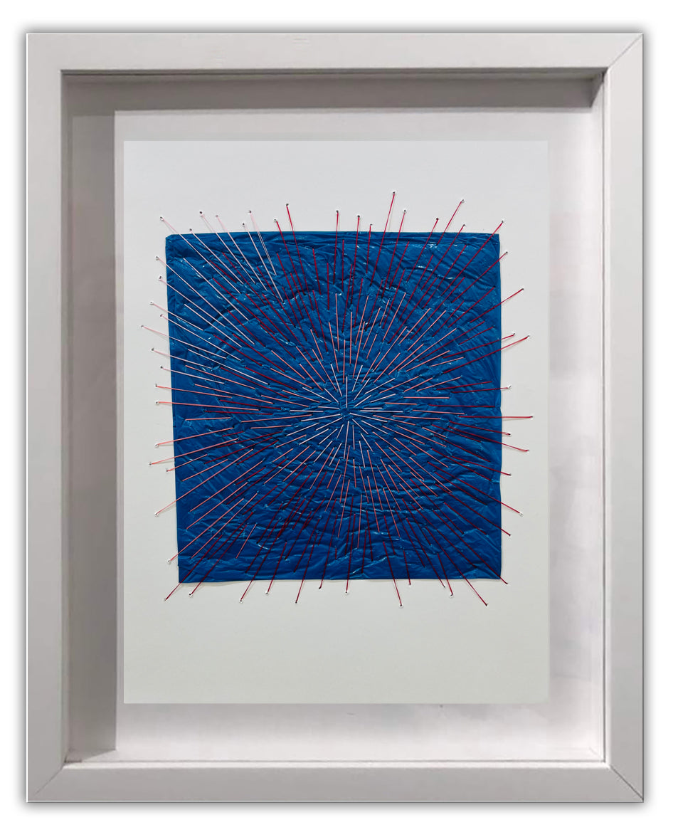A picture of a blue and red string art in a white frame.