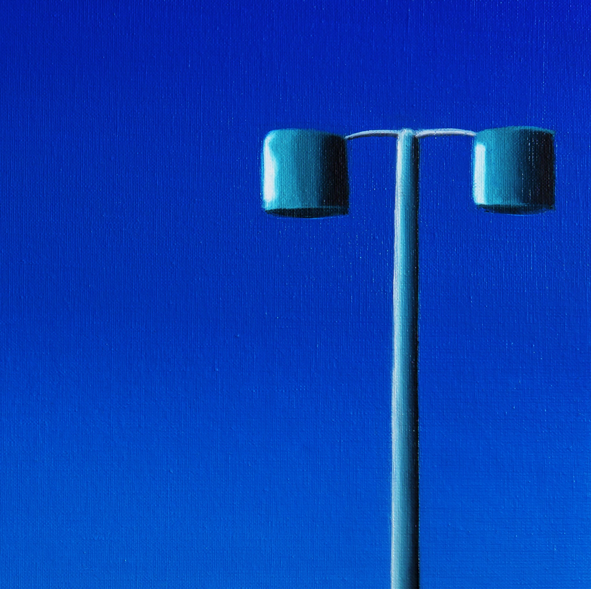 A stylized figure rides a tricycle along a coastal road under a vast blue sky.
