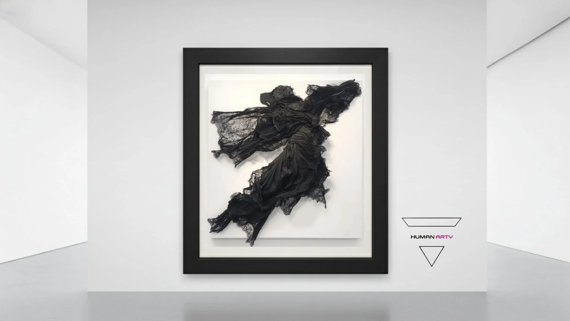 A framed artwork featuring a black, flowing fabric figure against a stark white background.