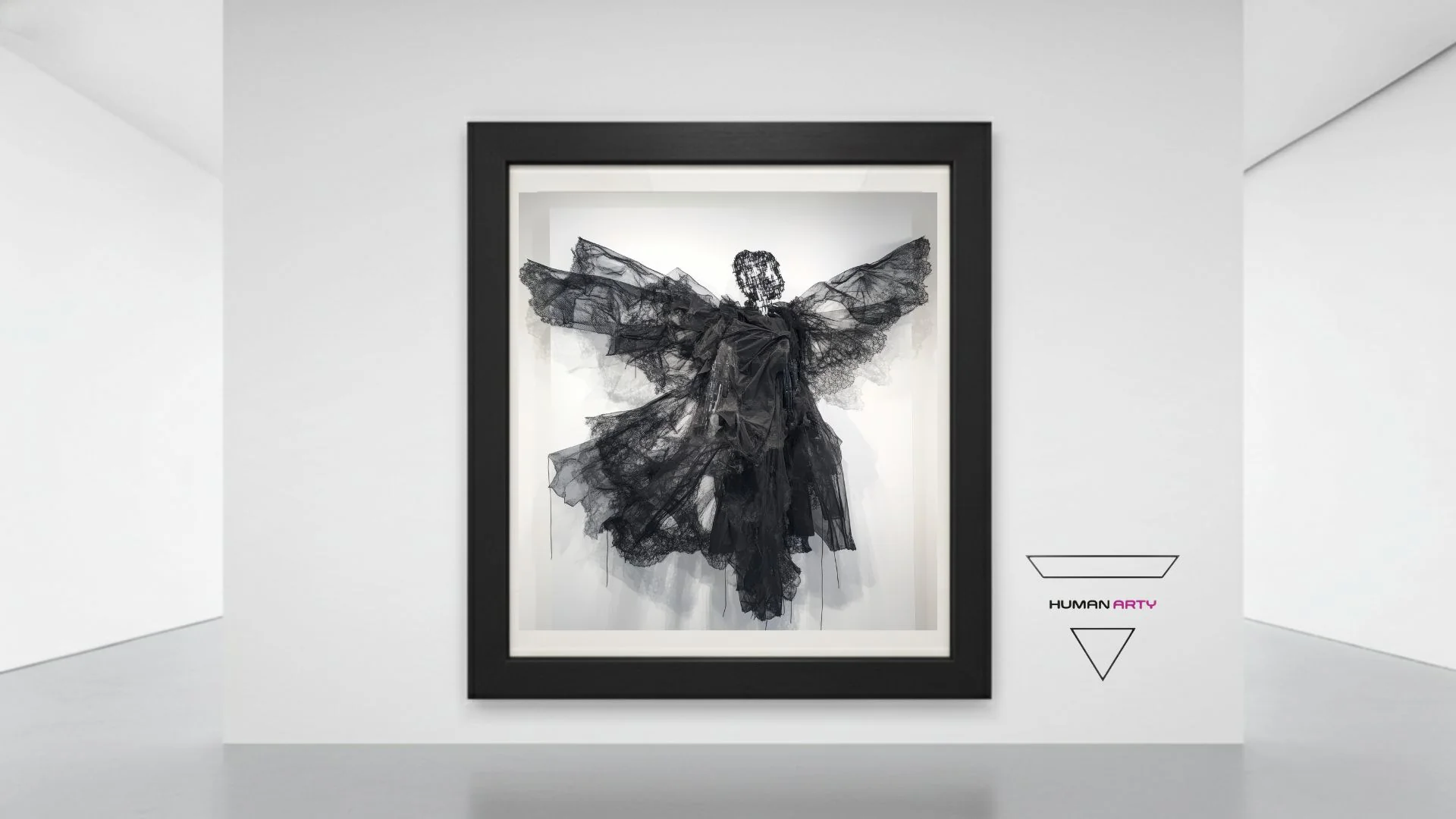 A framed black sculpture of a winged figure made from sheer, layered fabric against a stark white gallery wall.