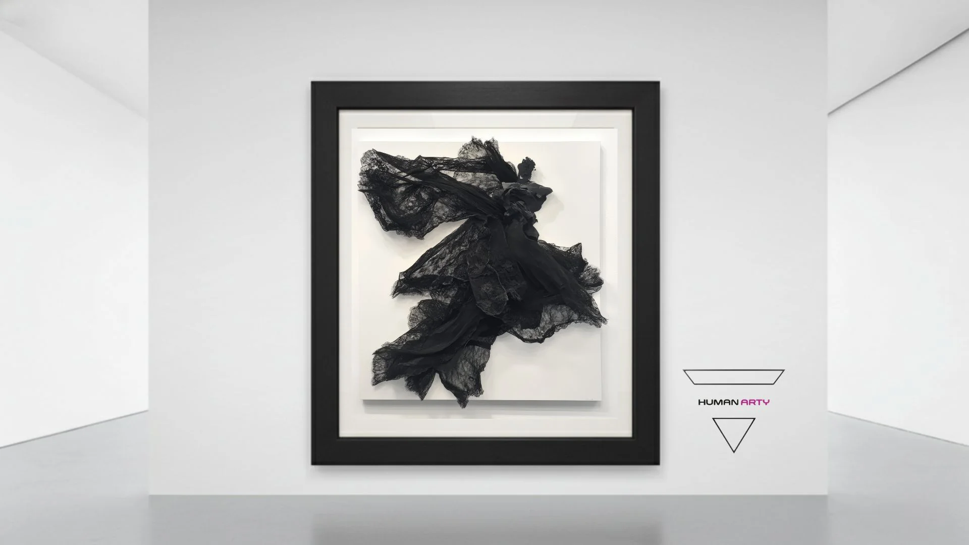 A black lace sculpture mounted on a white canvas within a minimalist gallery space.