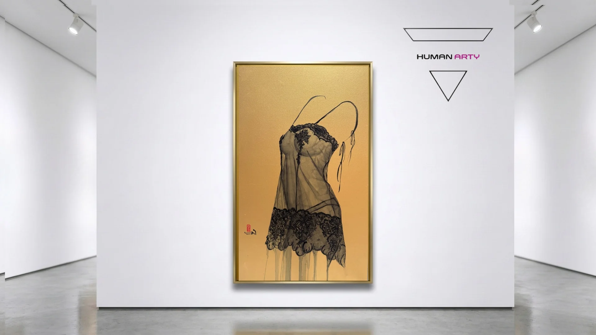 A framed artwork of a black lace garment against a textured gold background, displayed in a minimalist gallery space.