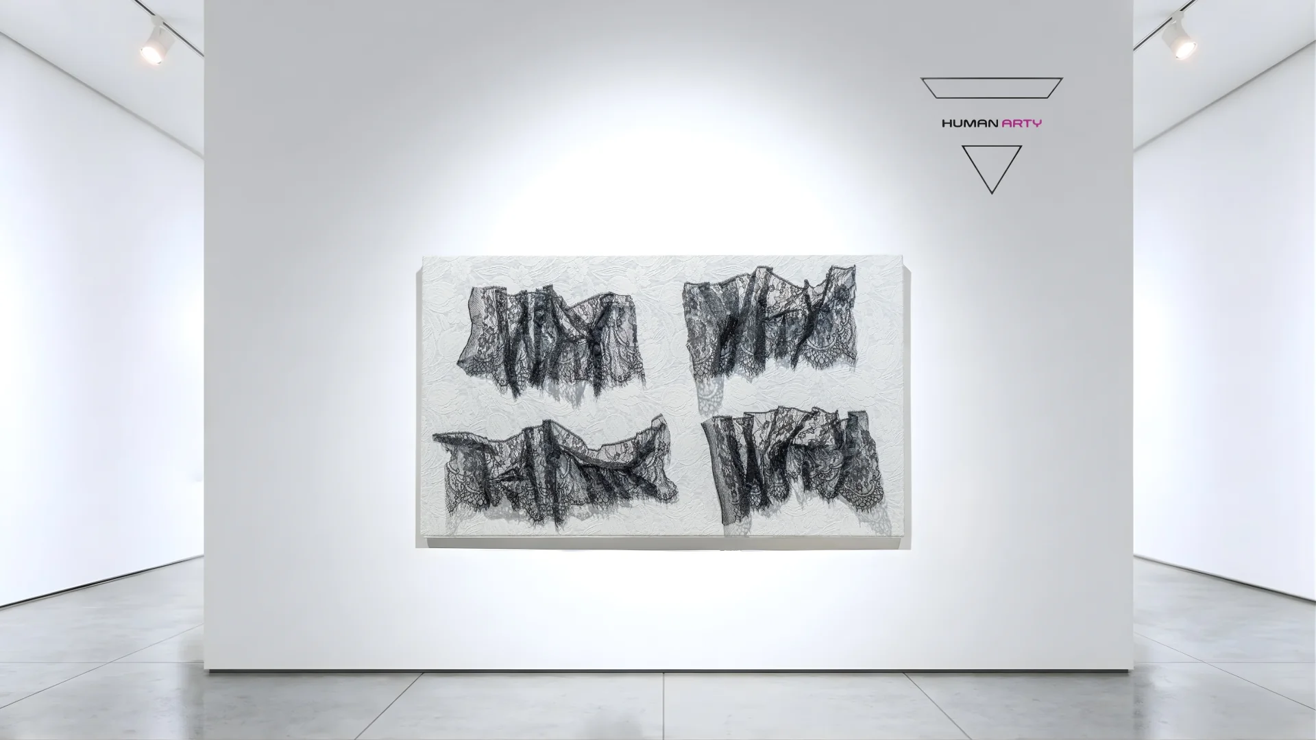 A minimalist gallery scene featuring a monochromatic textile artwork displayed on a white wall.