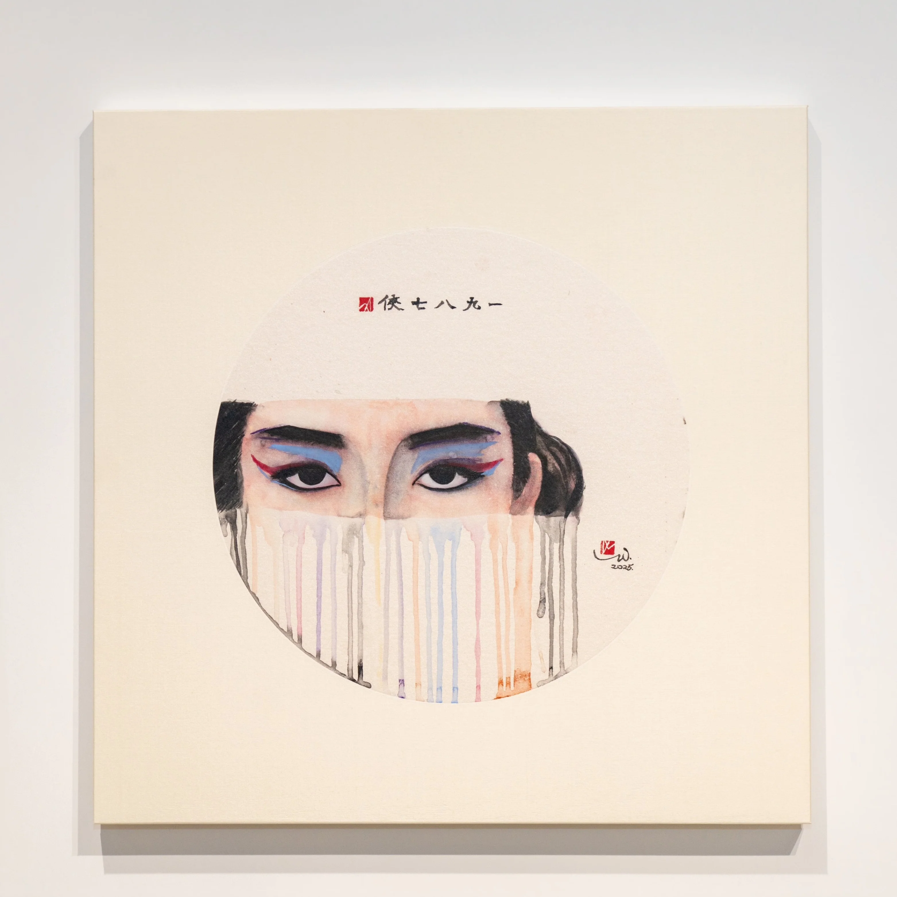 A square canvas in a gallery displays a portrait of a figure with stylized eyes and a mask-like face, framed by geometric wall art.