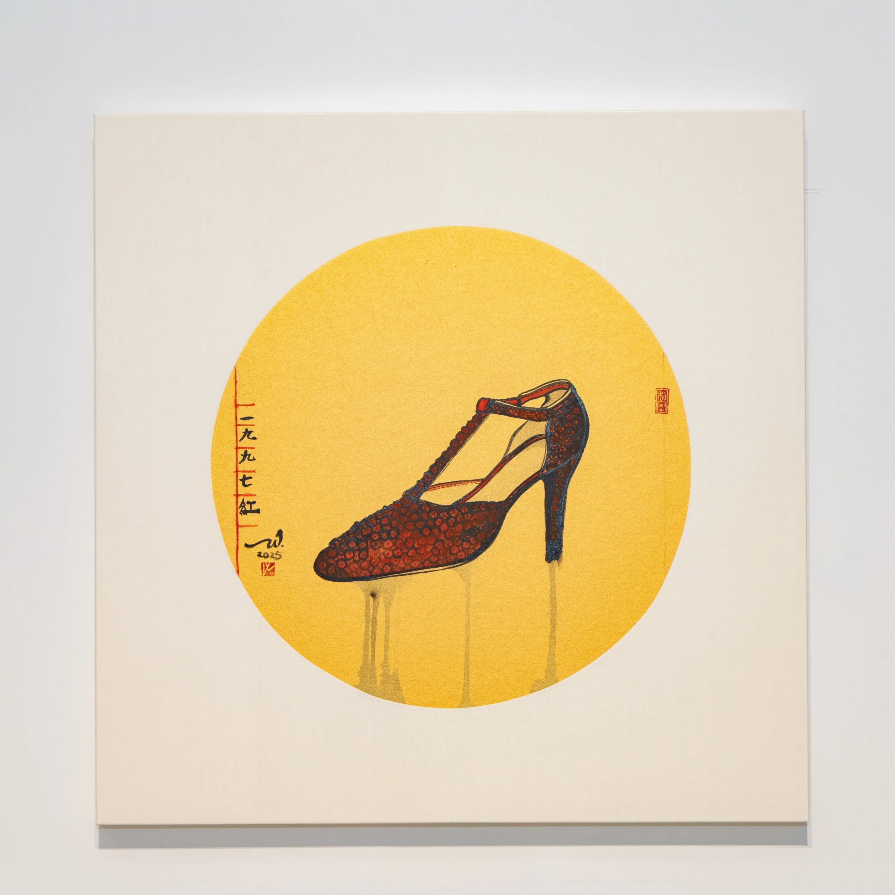 A high-heeled shoe is depicted within a yellow circle on a cream canvas, displayed in a minimalist gallery space.