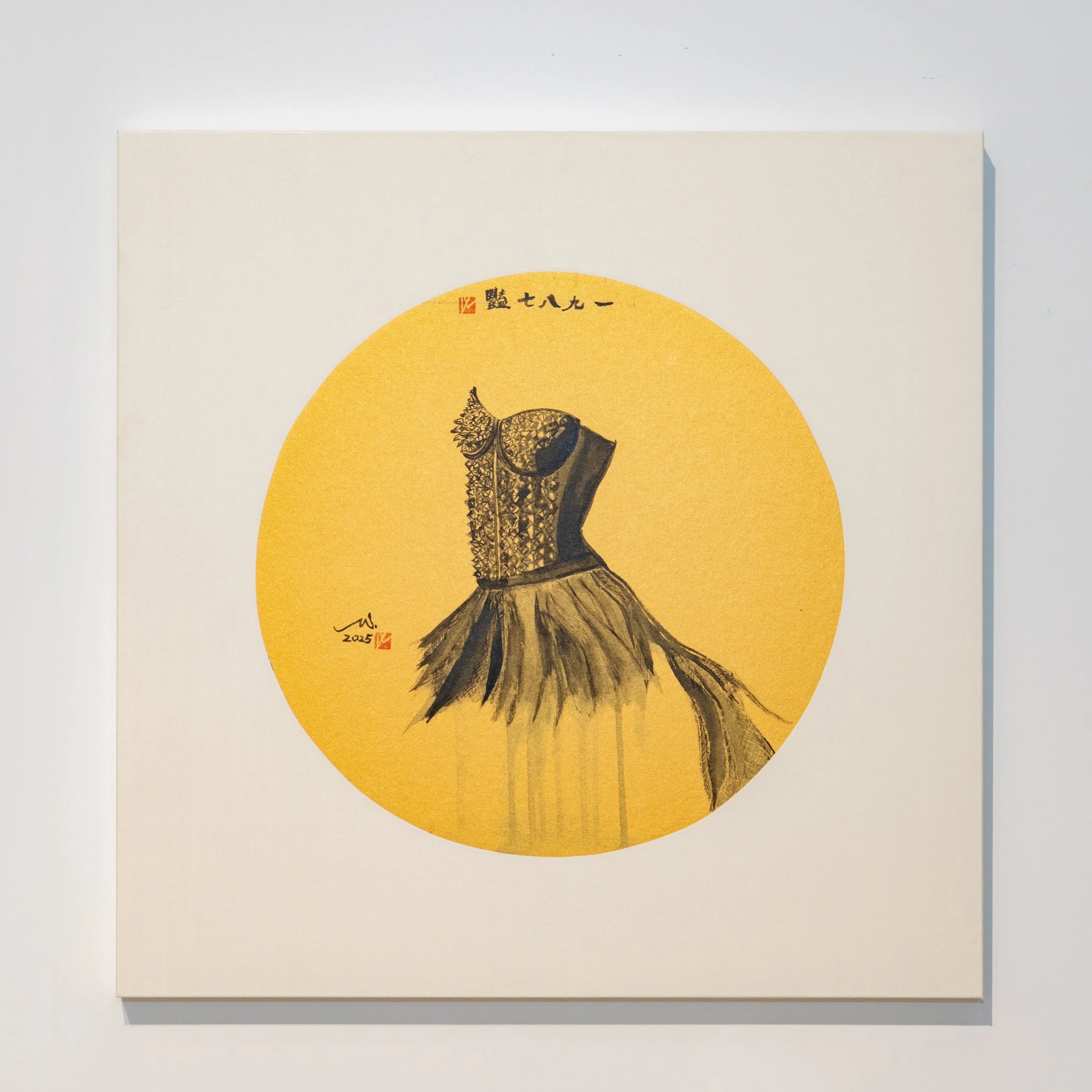 A minimalist gallery space featuring a square artwork with a yellow circle and a black dress silhouette.