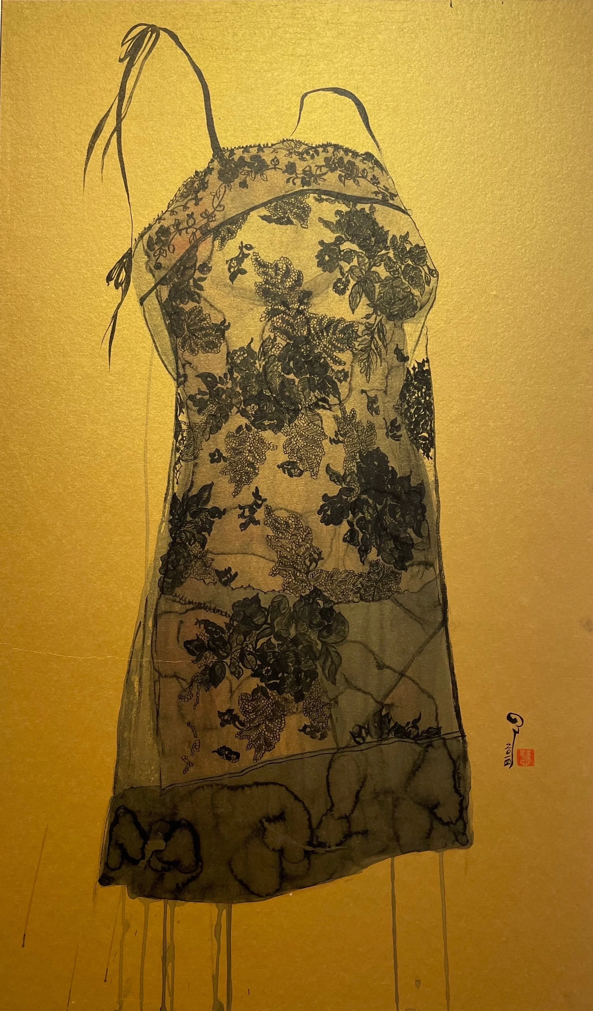 A framed artwork of a floral-patterned garment displayed in a gallery setting.