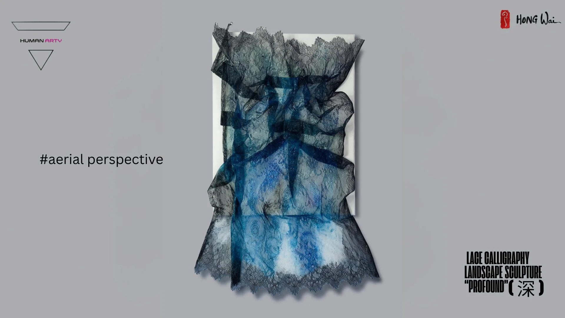 A sculptural arrangement of layered lace fabrics in deep blue and black tones, draped over a white rectangular base.