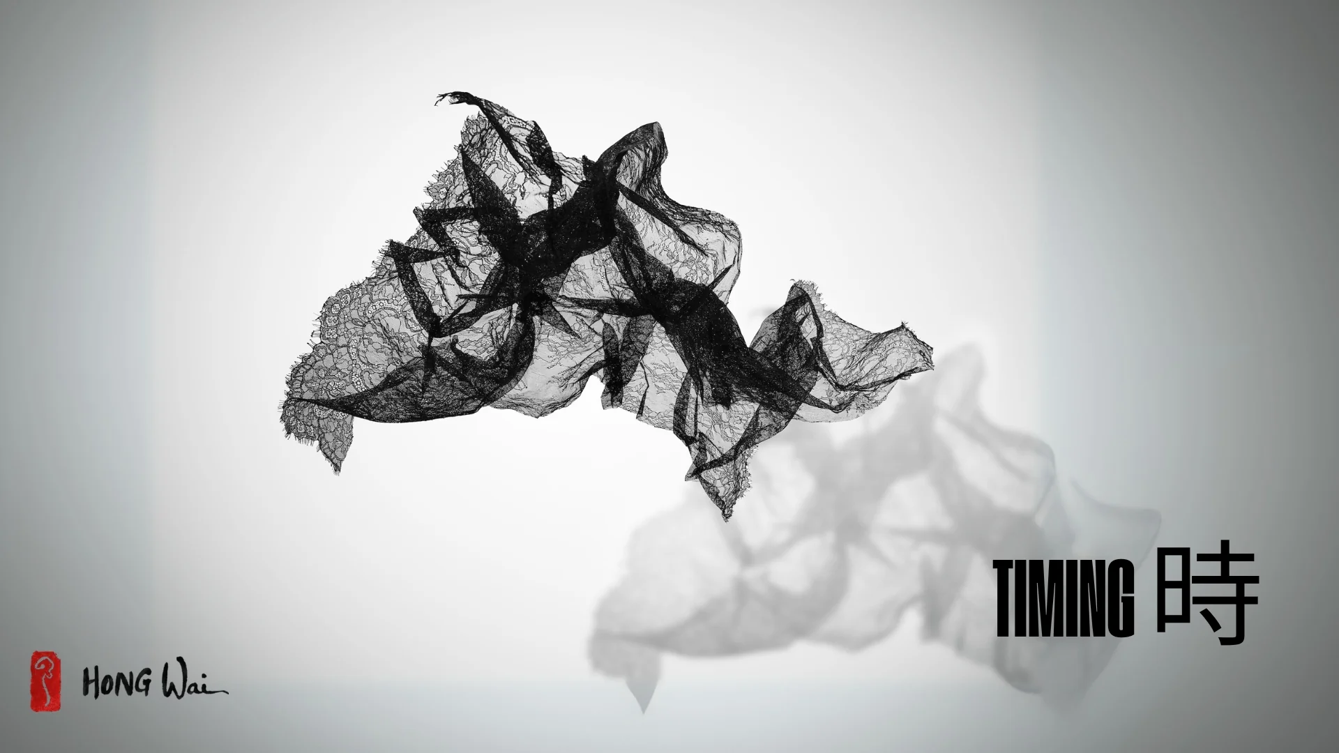 A solitary figure sits on a bench, gazing upward at floating black net-like sculptures against a stark white wall.