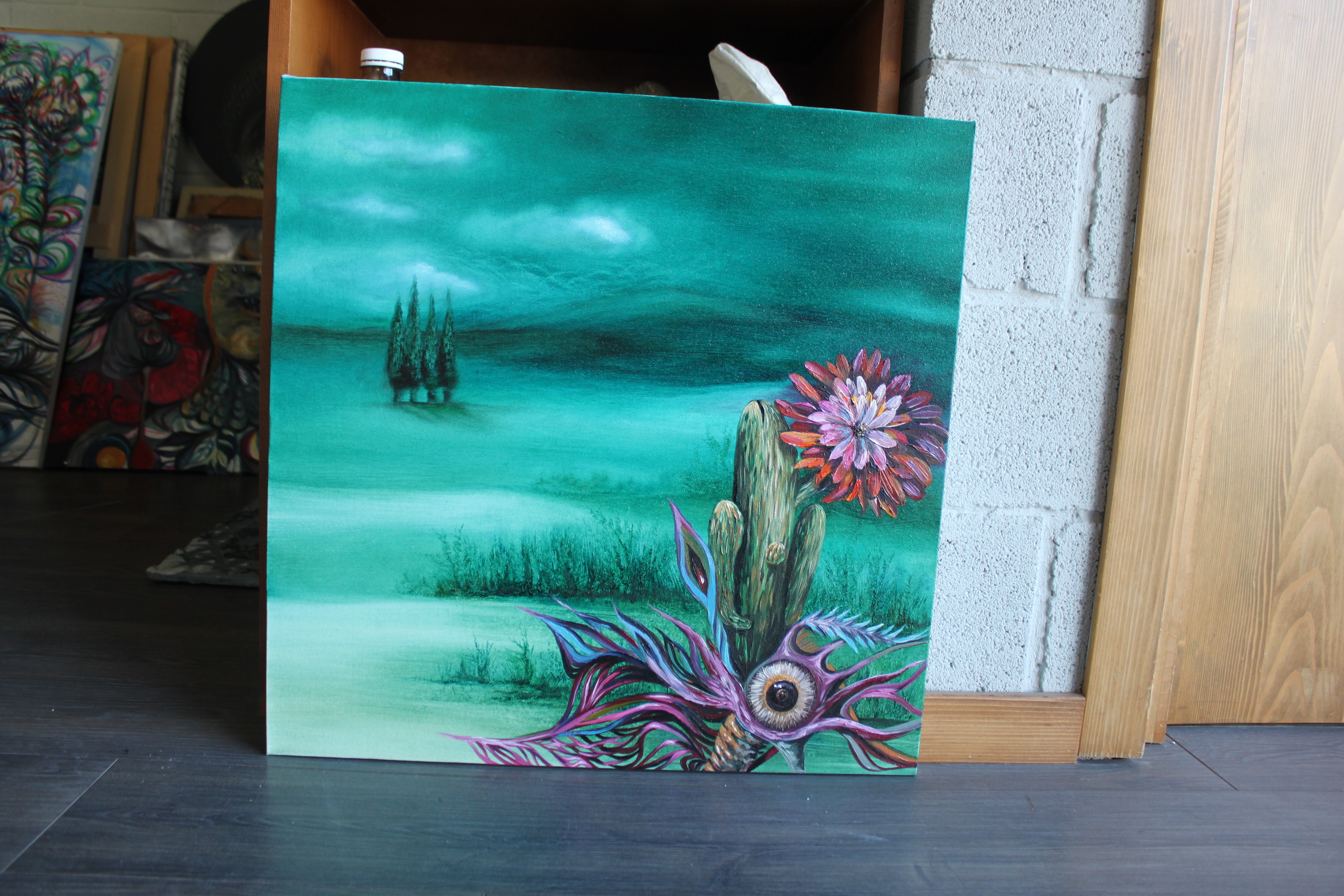 A painting of a cactus with a flower on it.