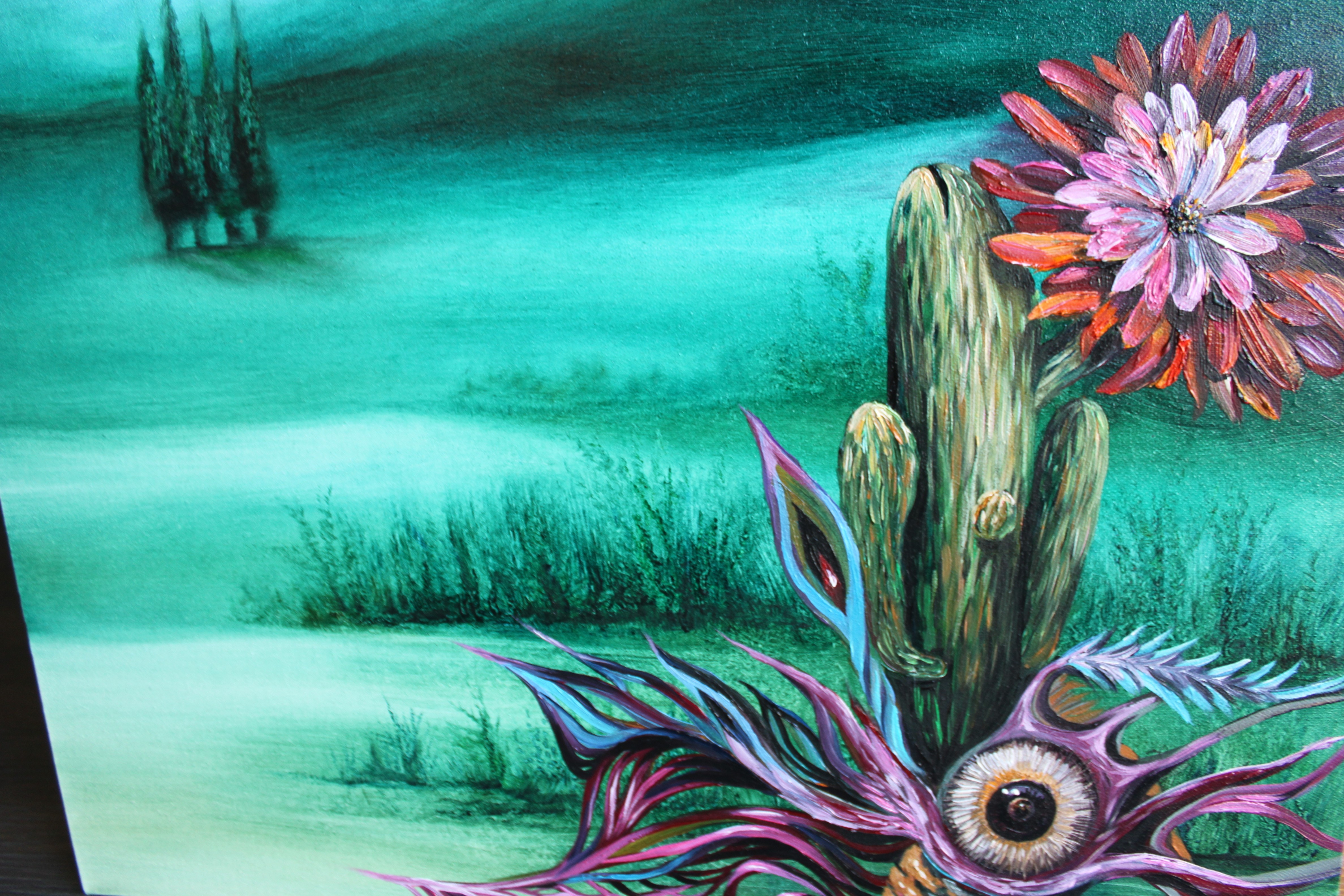 A painting of a cactus with a flower on it.