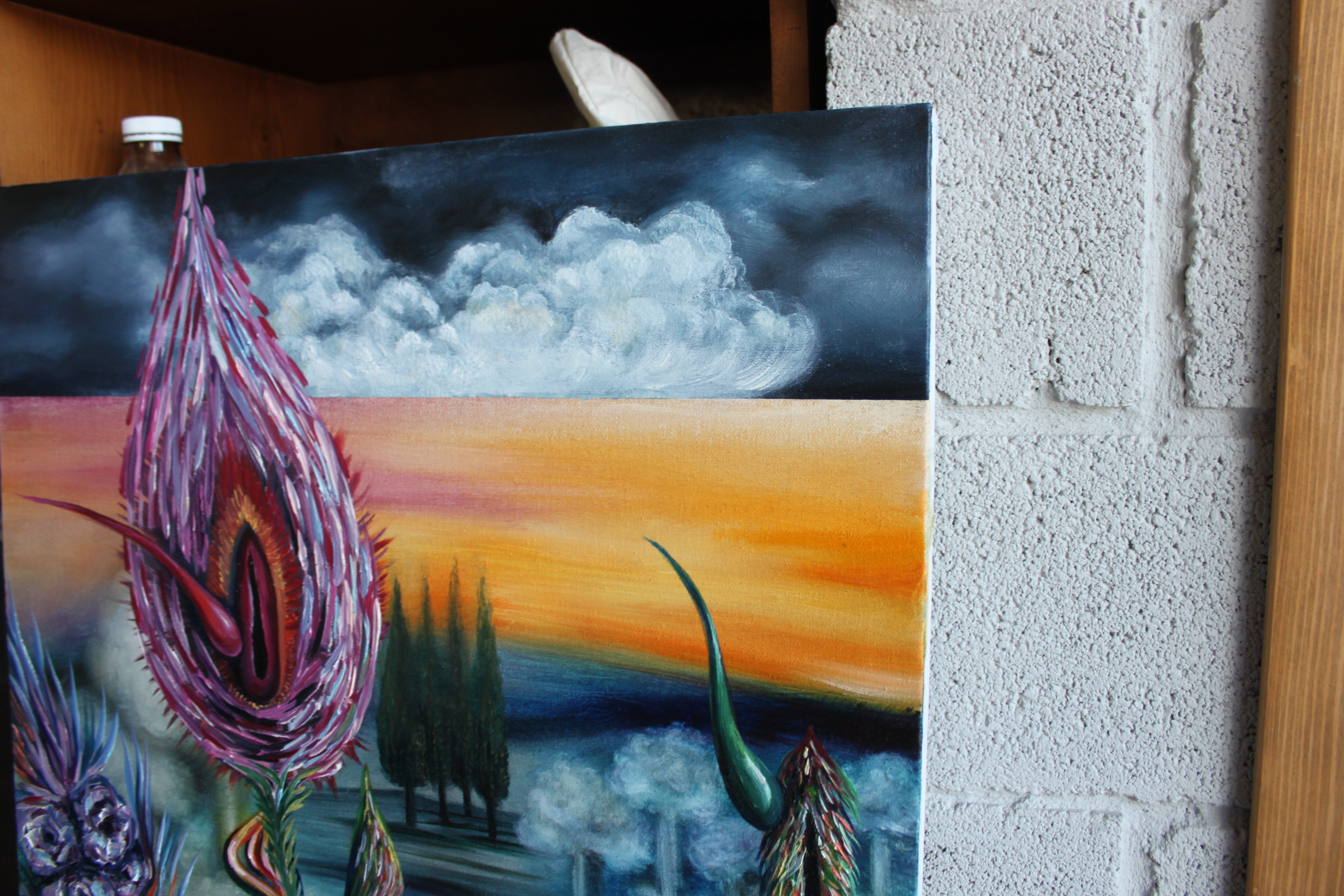 A painting of a thistle flower on a canvas in a room.