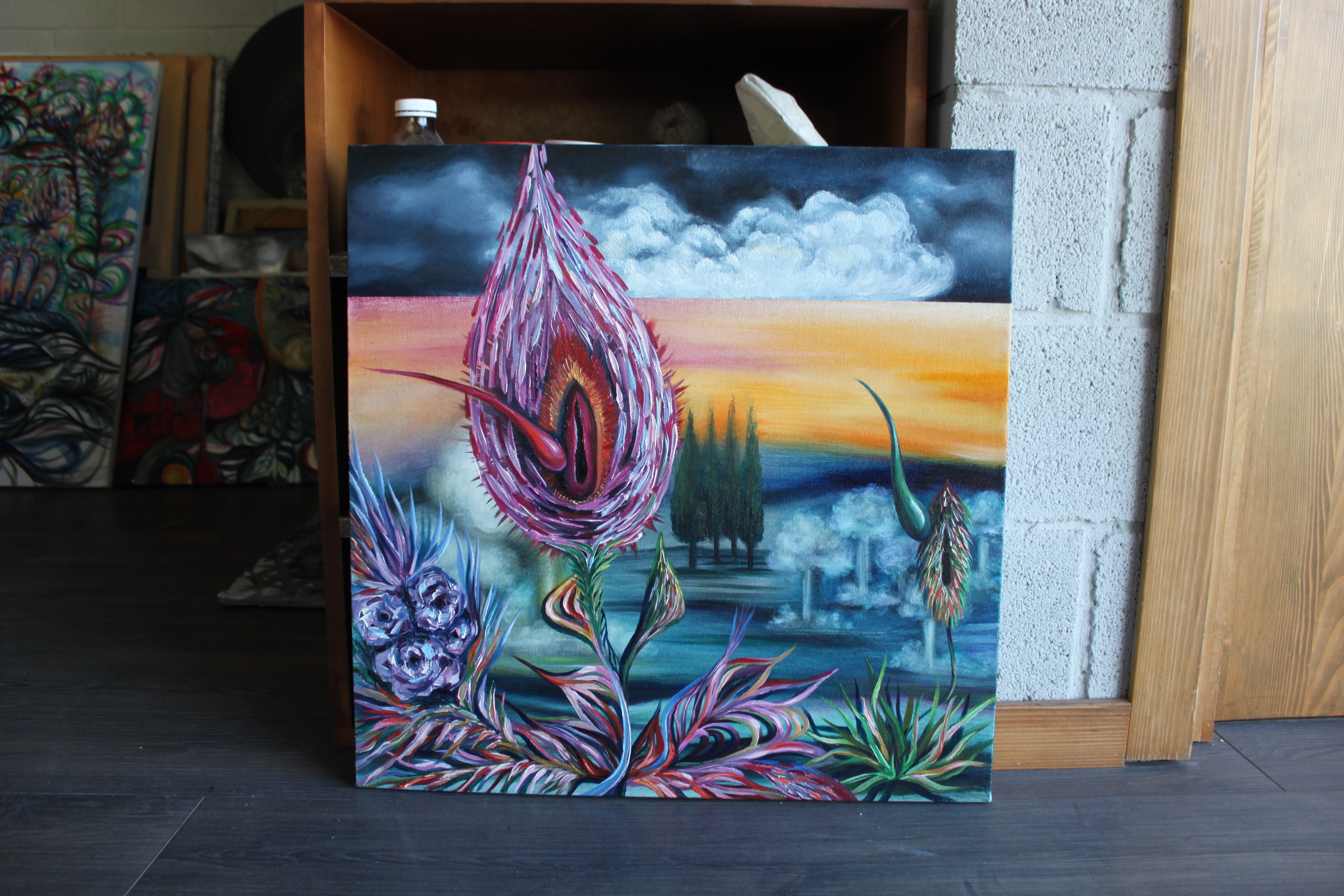 A painting of a thistle flower on a canvas in a room.
