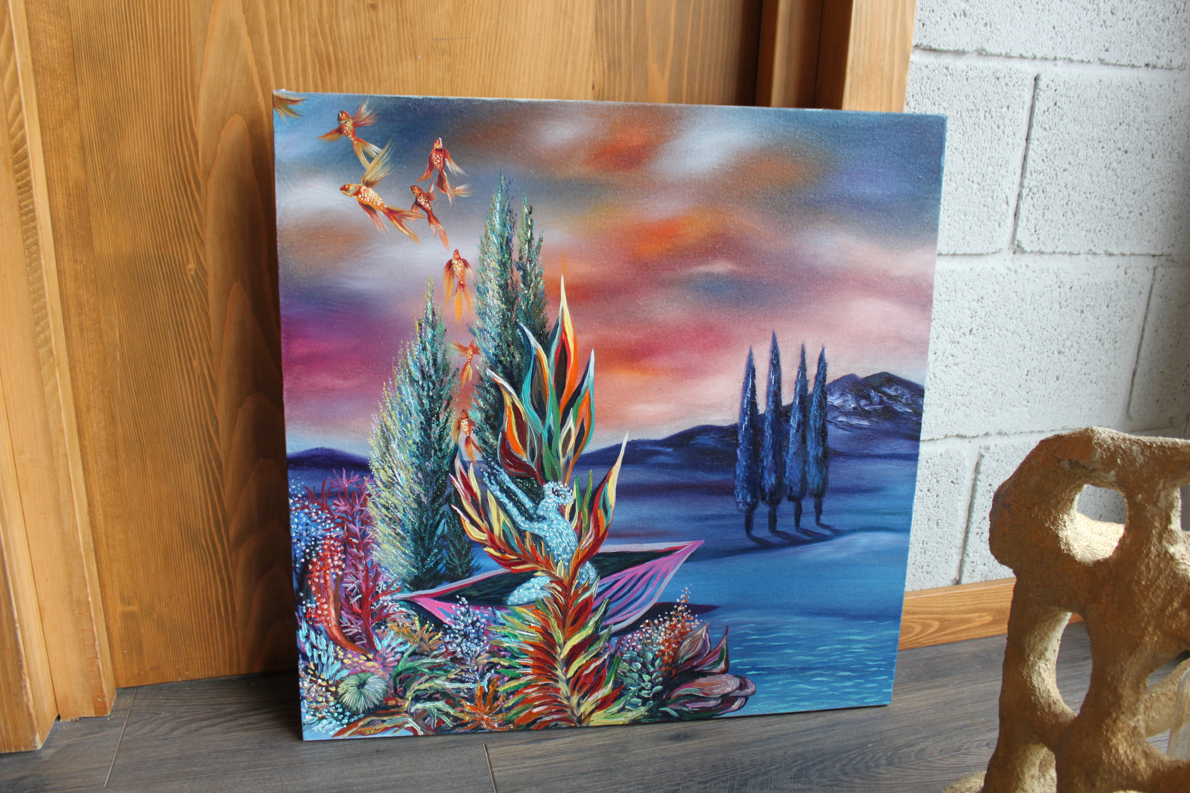 A painting on a table in a room with other paintings.