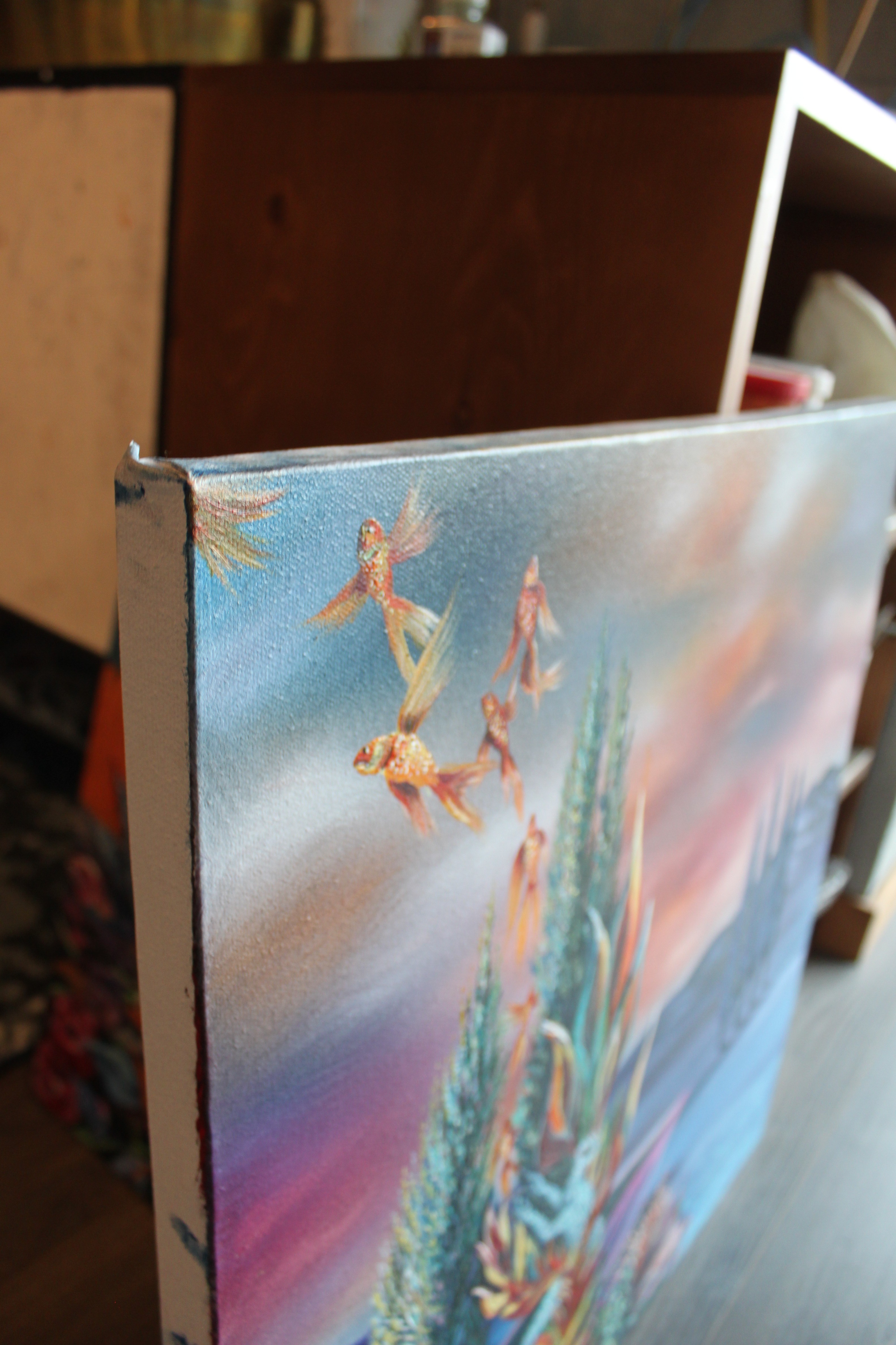A painting on a table in a room with other paintings.