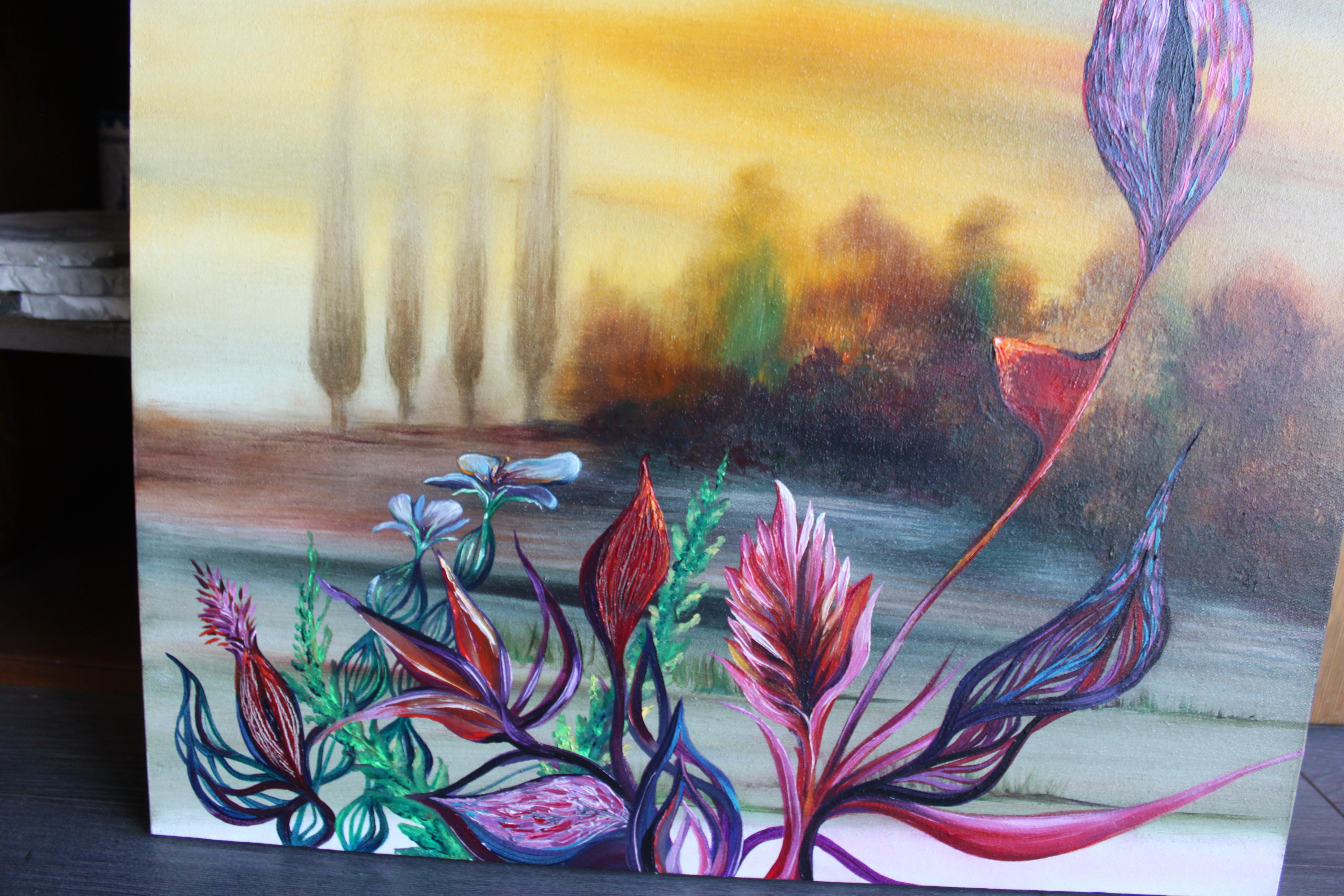 A painting on a wooden table in front of a shelf.