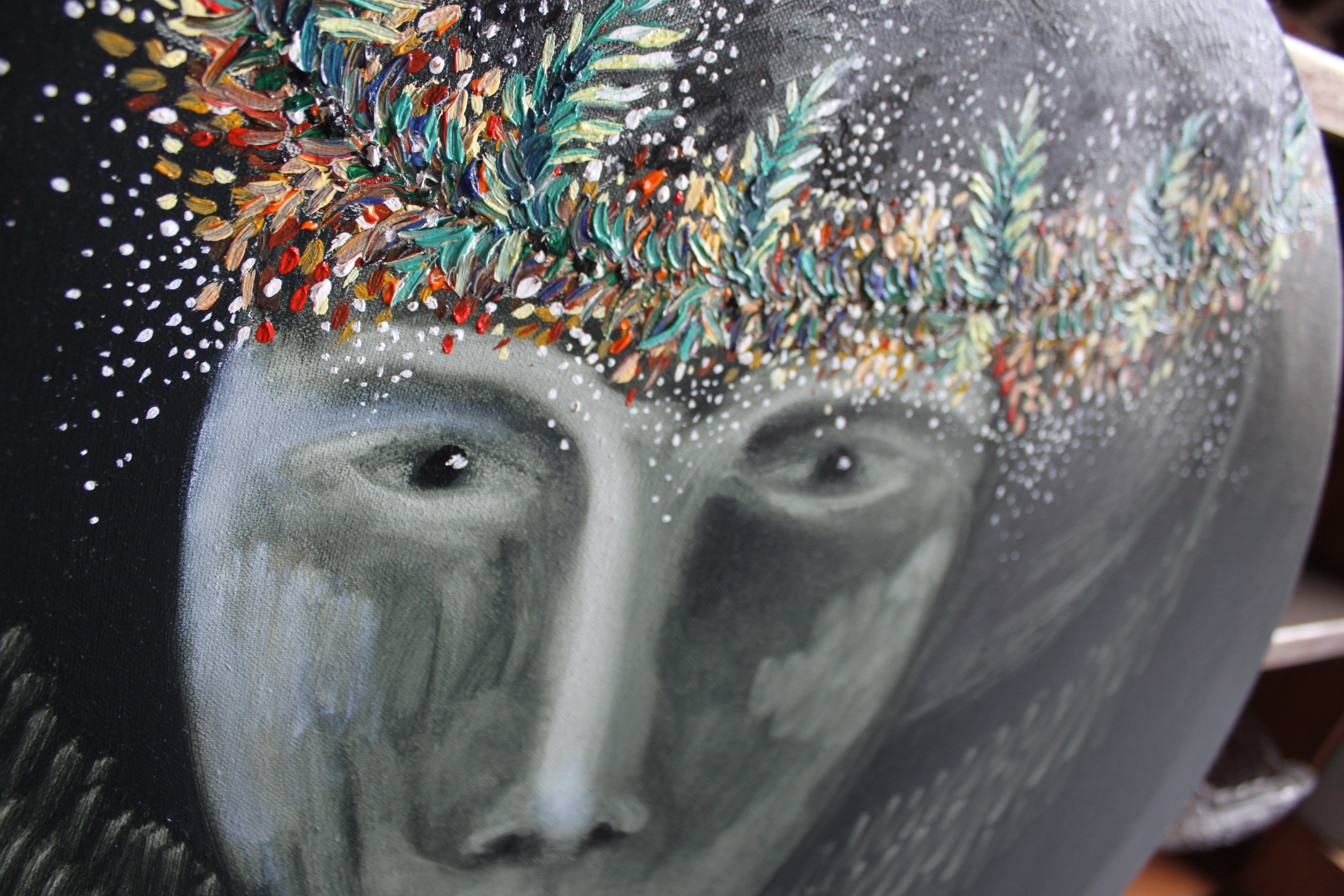 A close up of a painting of a woman's face on a pumpkin.