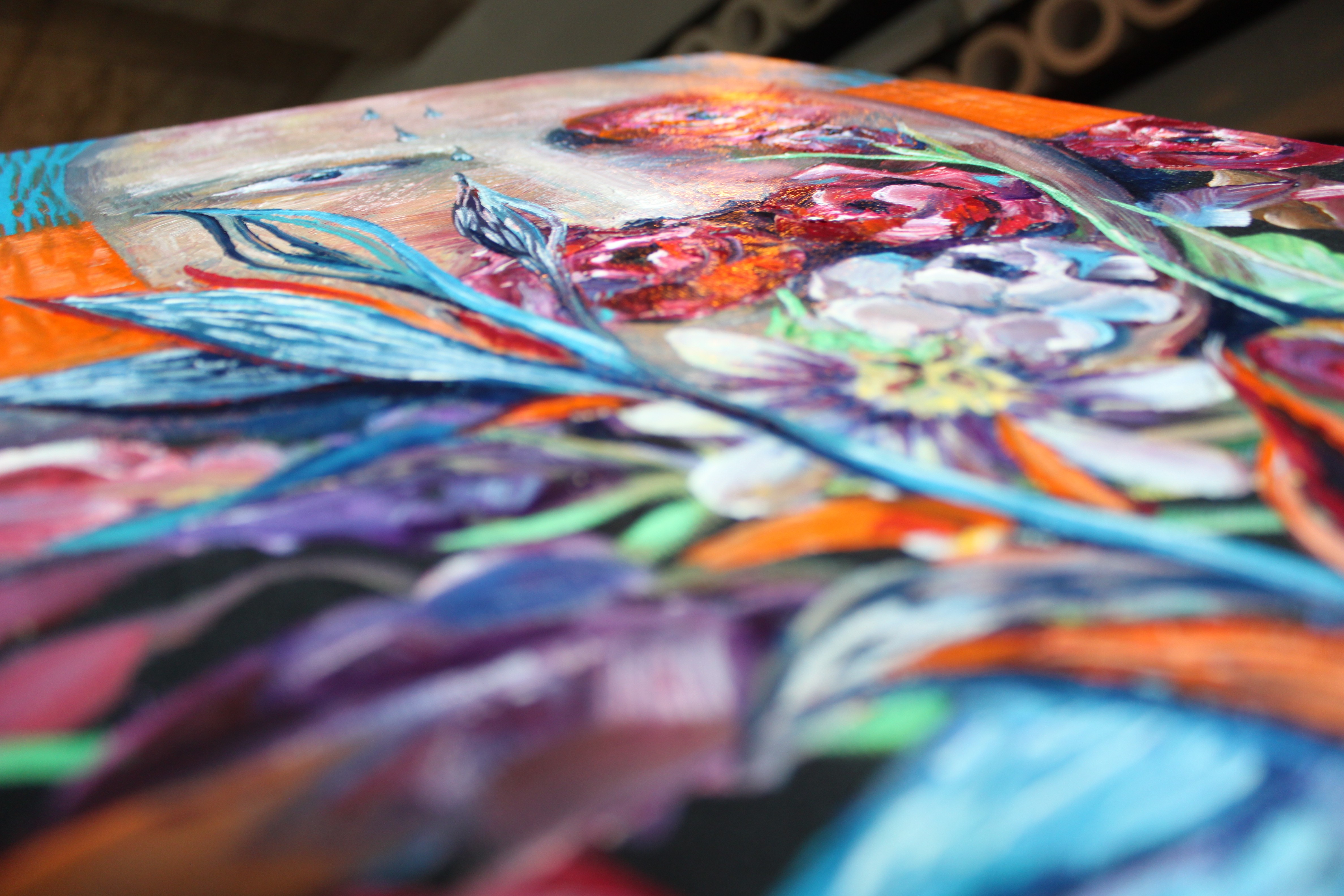 A painting of a woman's face on a wooden table.