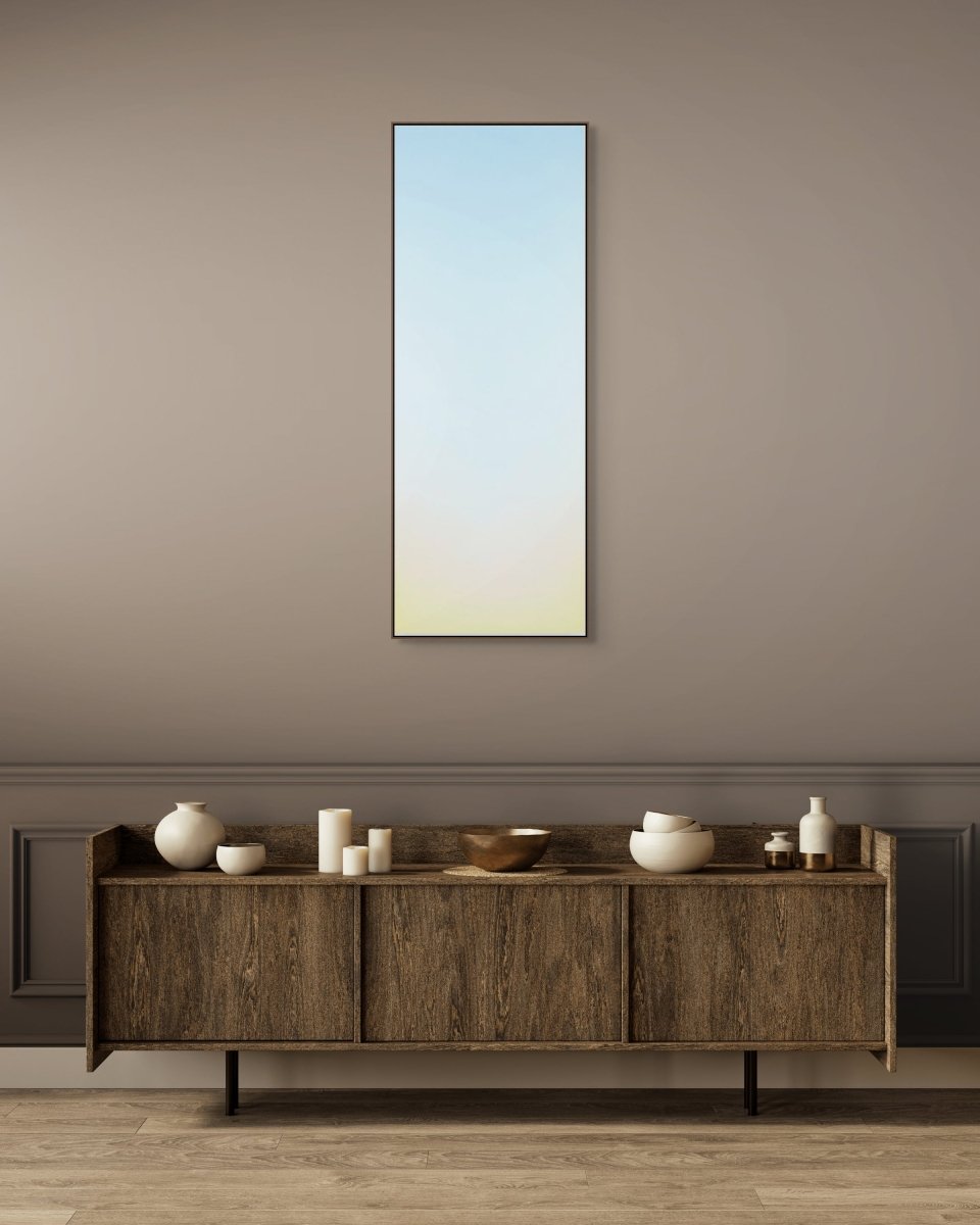 A minimalist vertical gradient artwork transitioning from pale blue to soft yellow.