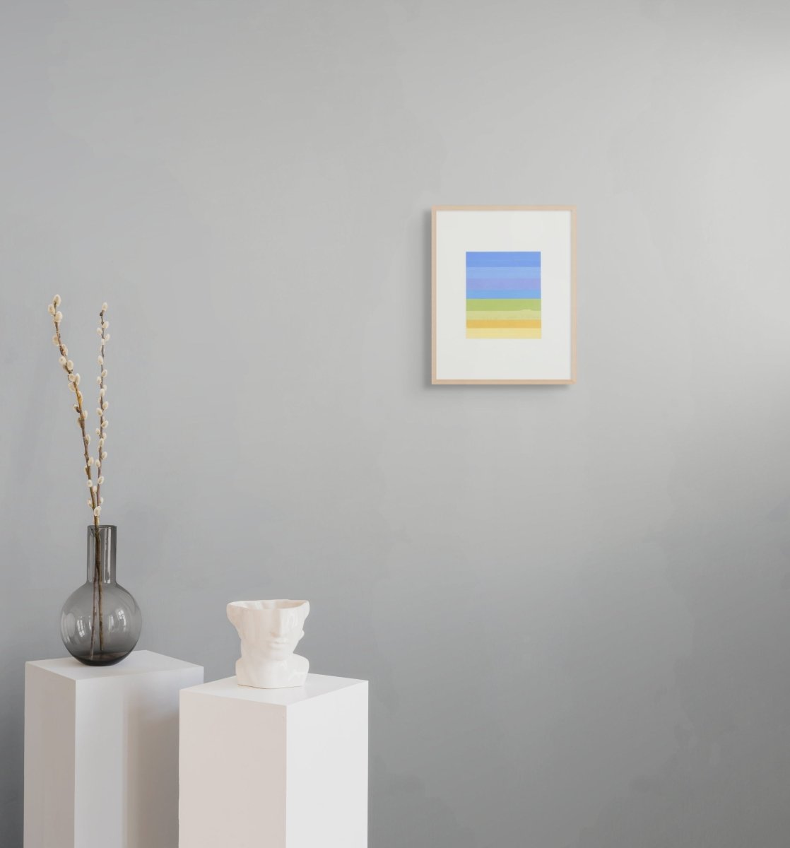 A minimalist abstract print featuring a vertical stack of horizontal bands in soft blues, greens, and yellows.