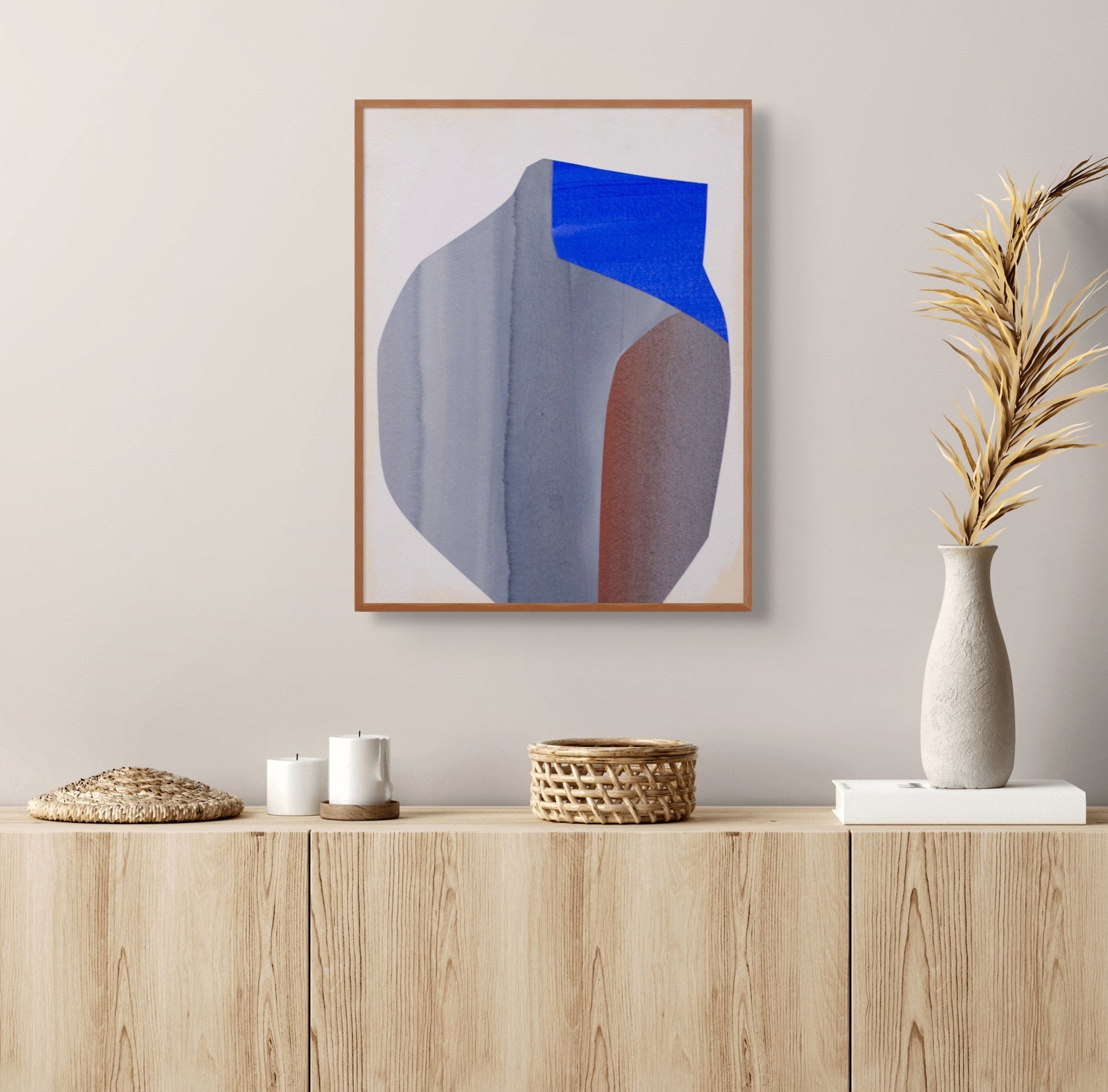 An abstract composition featuring a large, geometric form in muted blue and brown tones against a pale background.