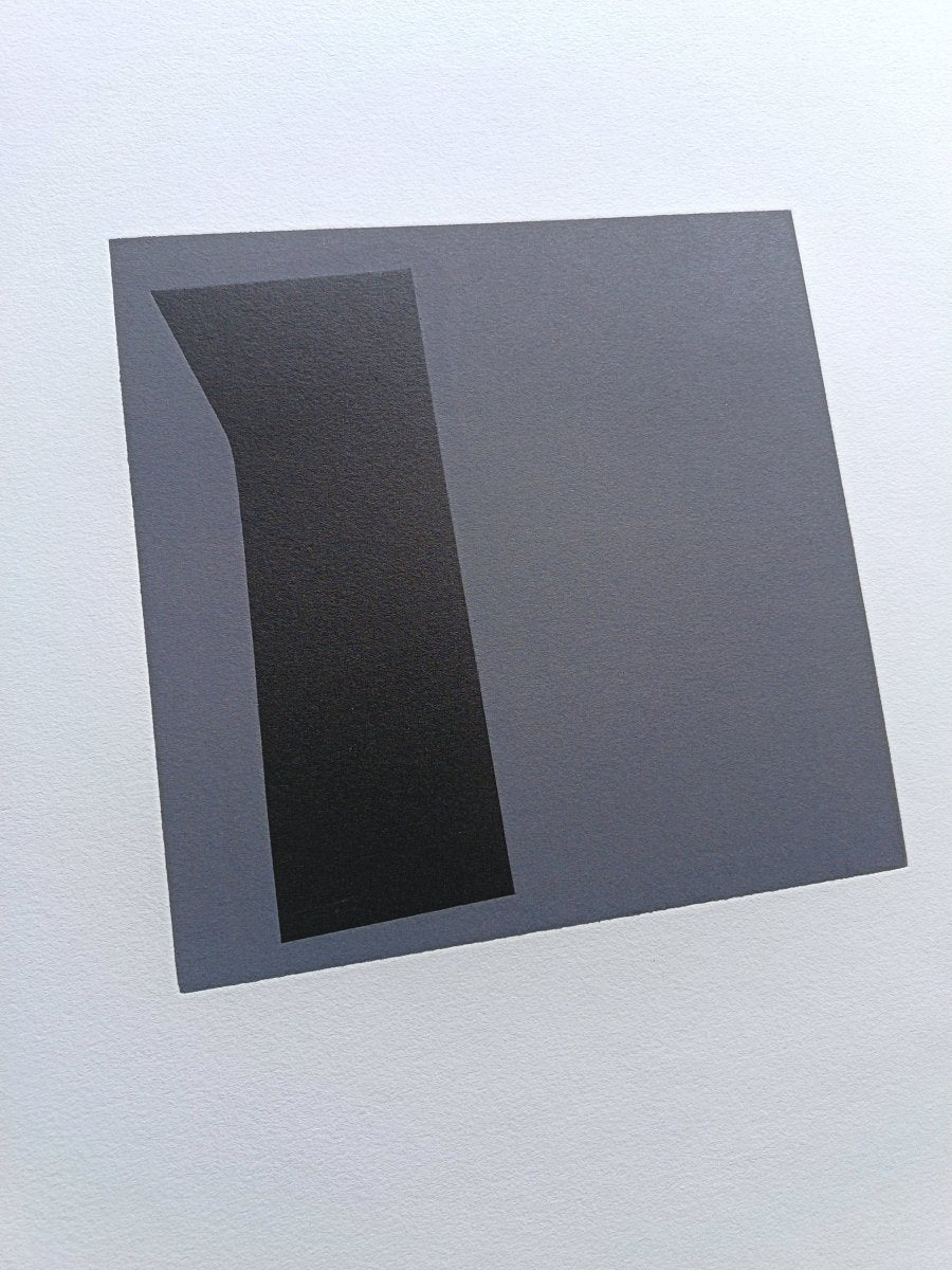 A triptych of minimalist abstract prints featuring dark geometric shapes on gray squares against white backgrounds.