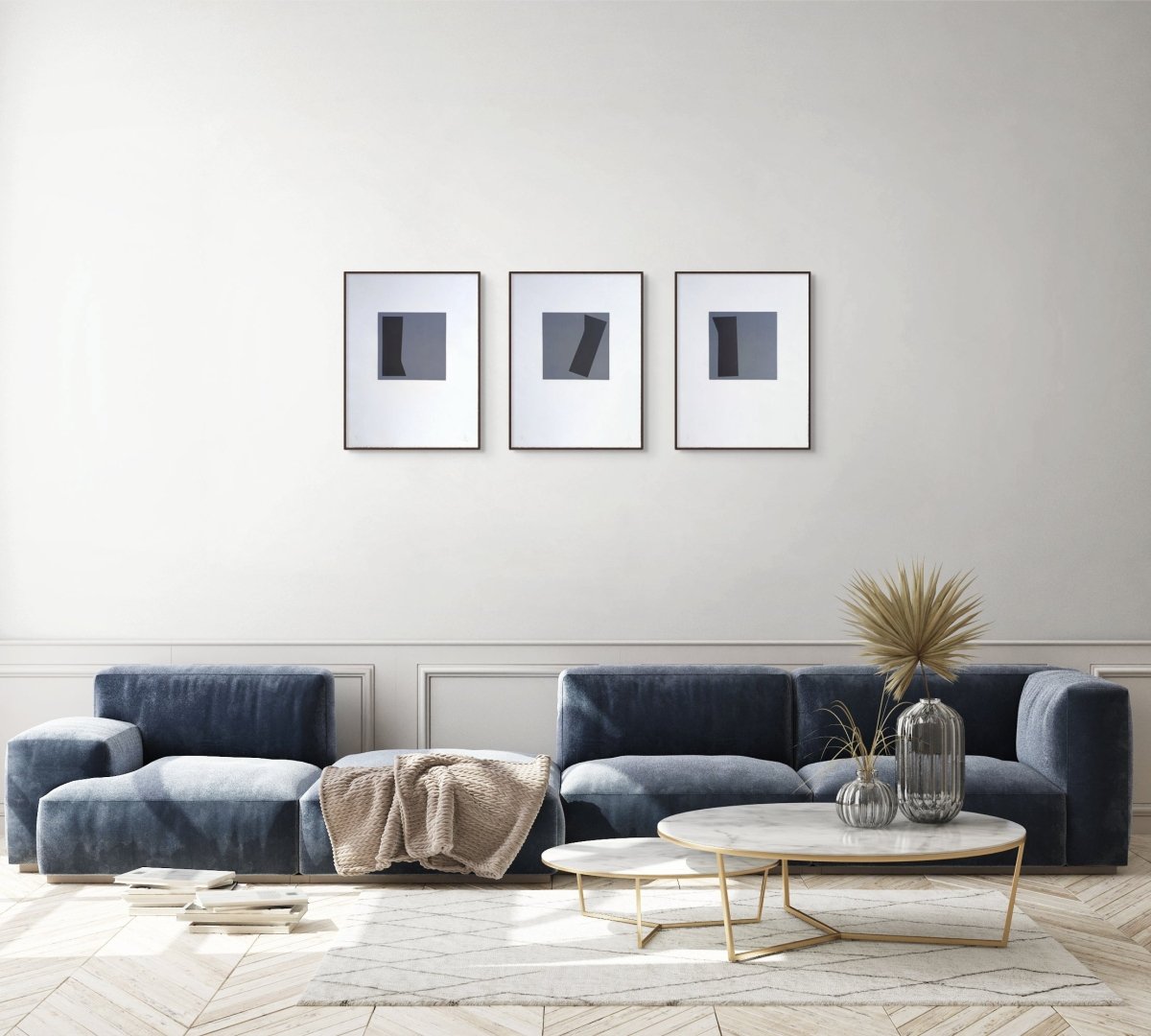 A triptych of minimalist abstract prints featuring dark geometric shapes on gray squares against white backgrounds.