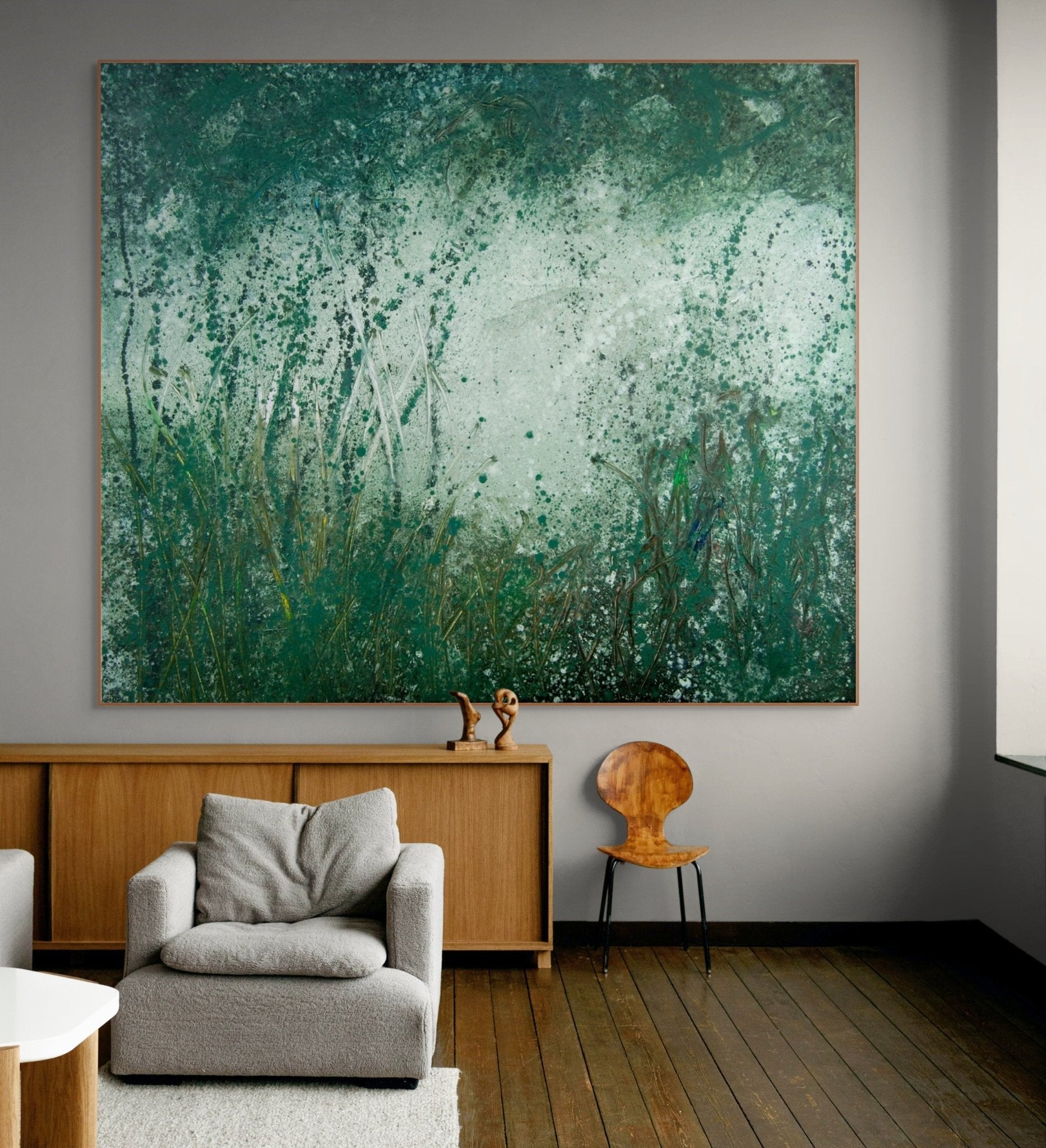 An abstract landscape featuring a grassy foreground and a misty, textured background.