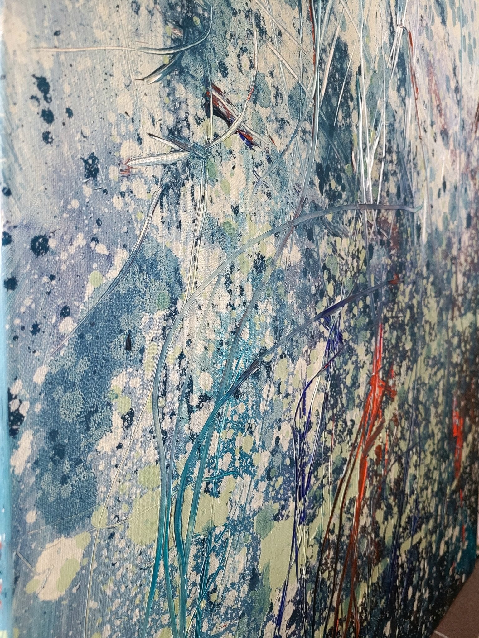 An abstract composition of tangled, grass-like forms rising from a textured, splattered background.