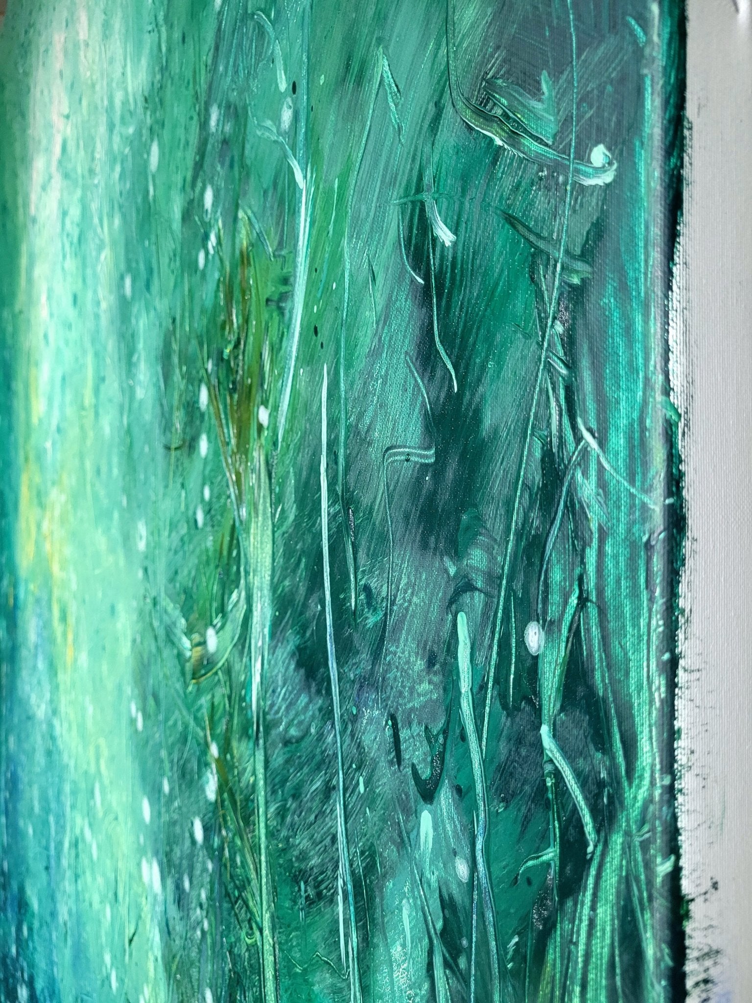 An abstract green and blue painting with a glowing center.