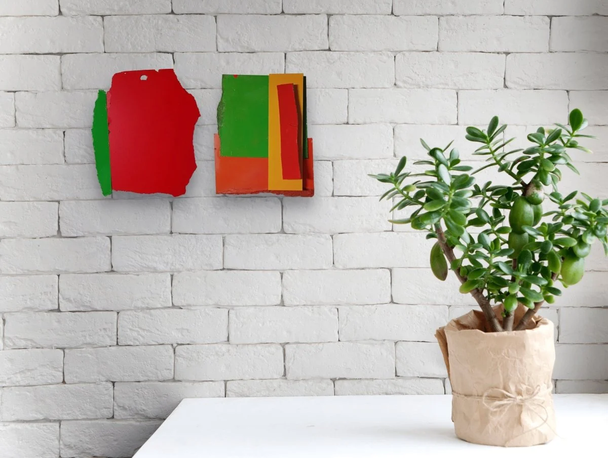 A bold, abstract composition featuring a red shape with a green vertical strip and a hole at the top.