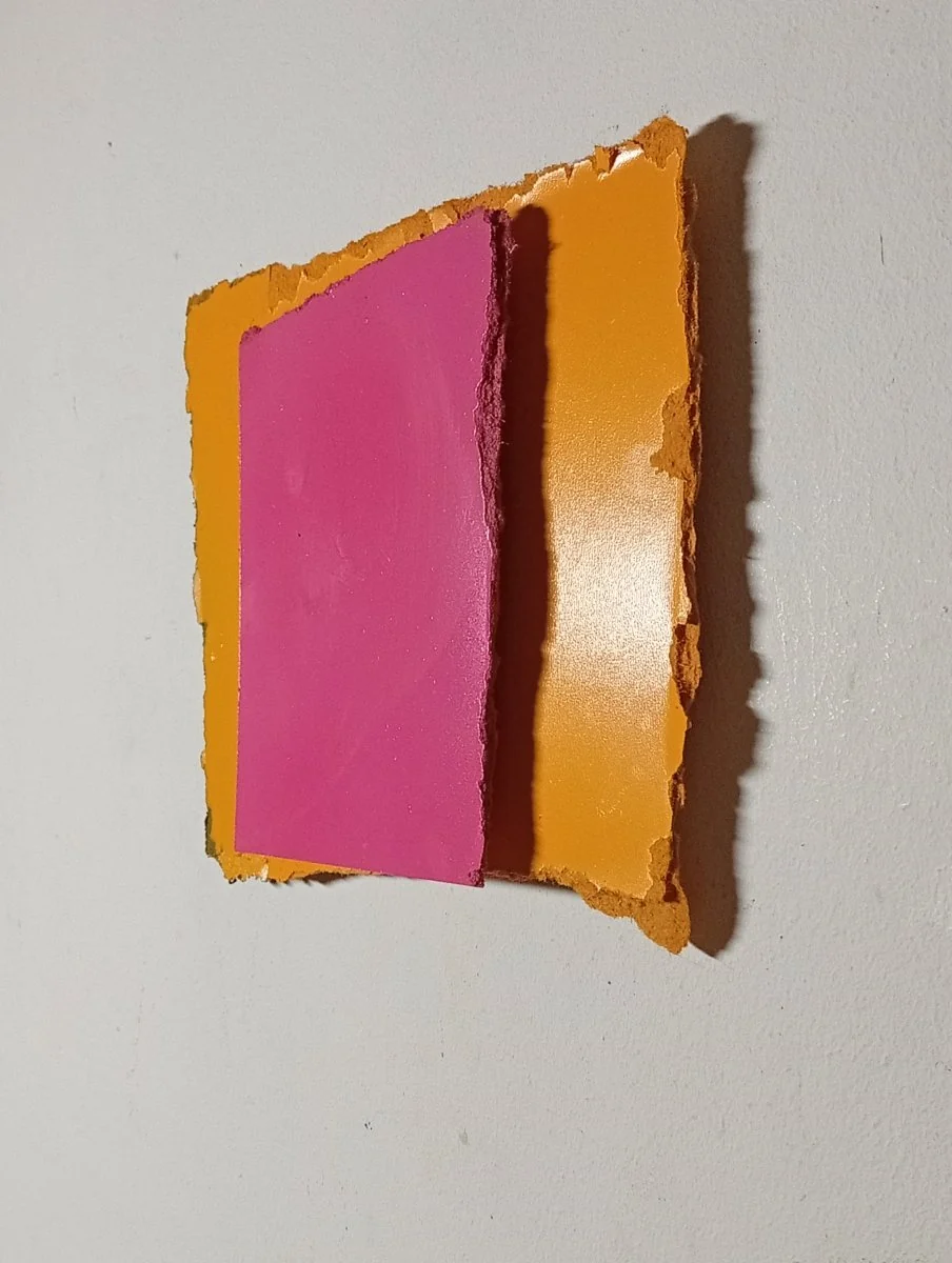 A layered abstract composition featuring a textured orange frame surrounding a smooth magenta rectangle.