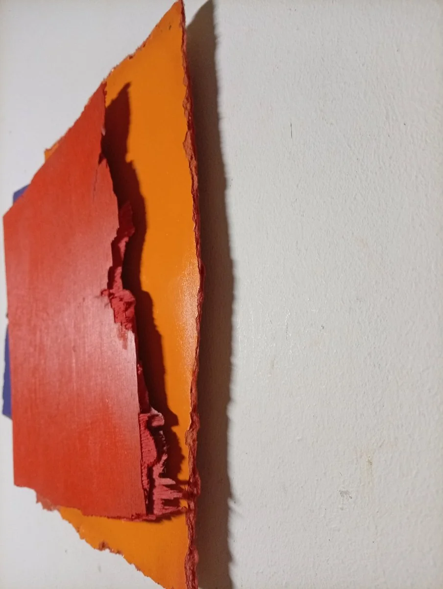 A layered abstract composition of three textured rectangular panels in bold primary colors.