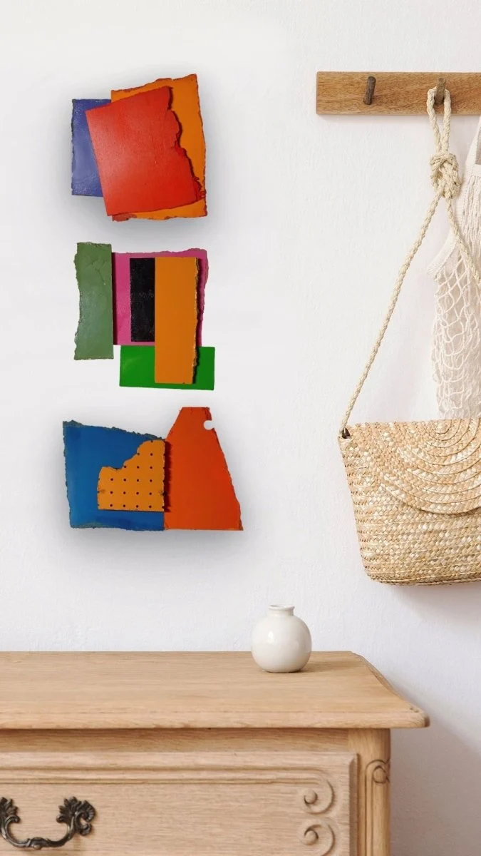A layered abstract composition of three textured rectangular panels in bold primary colors.